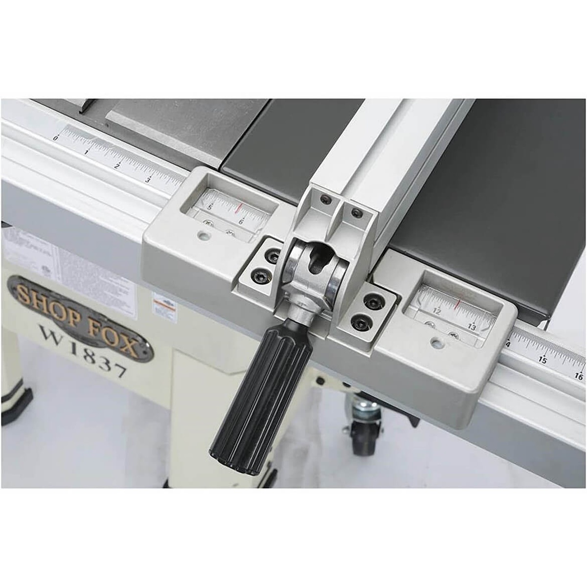 Close-up of the Shop Fox W1837 2 HP 10-Inch Hybrid Open Stand Table Saw rip fence locking mechanism and measurement scale for repeat rip cuts on sheet goods and hardwood