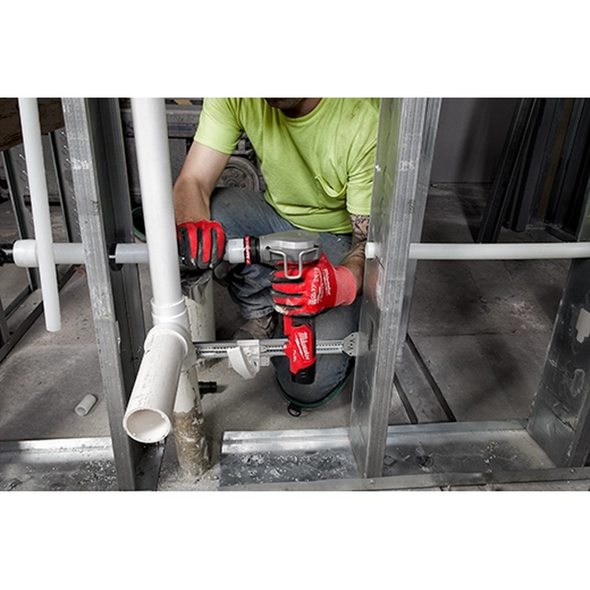 Milwaukee M12 FUEL ProPEX Expander being used between wall studs on PEX plumbing during a rough-in installation