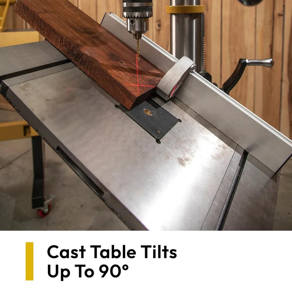 Powermatic PM2820EVS Drill Press lining up a drilling point on hardwood with the cross hair laser, fence, and cast table in a woodworking shop