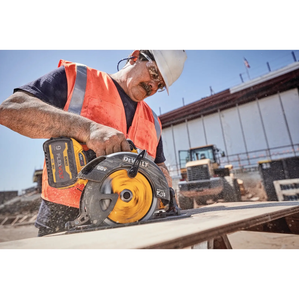 DEWALT 60V MAX Brushless Cordless 7-1/4 in. Circular Saw with Electronic Brake Kit cutting sheet material on an active construction jobsite with visible sawdust and battery installed