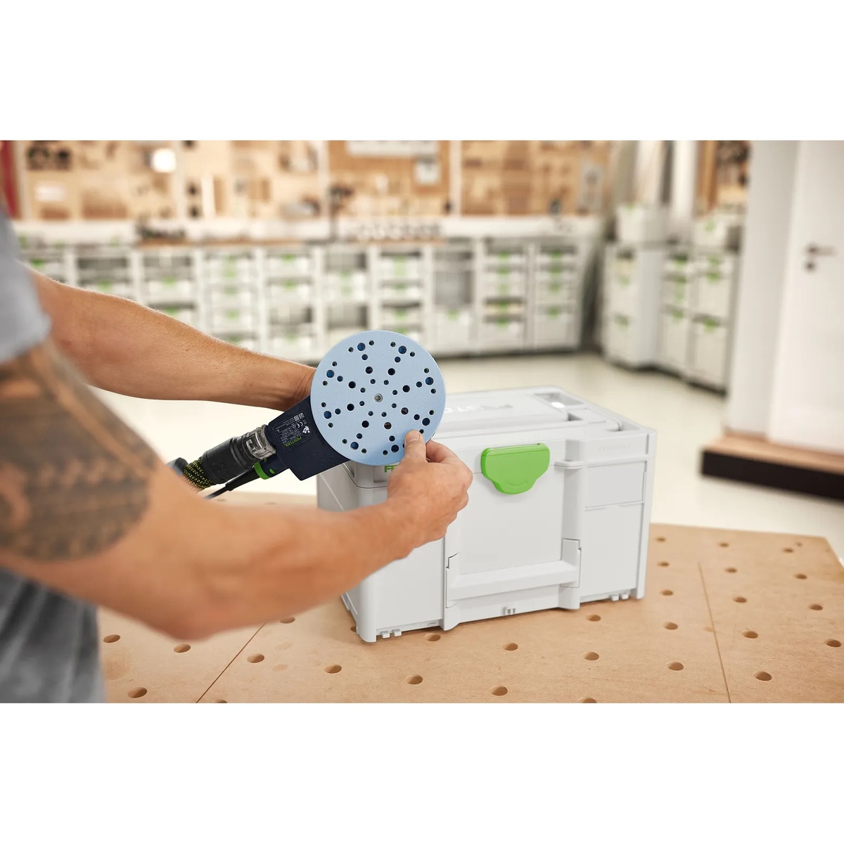 Festool 576785 Systainer3 SYS-STF D150 beside a Festool sander on a perforated workbench in a cabinet shop