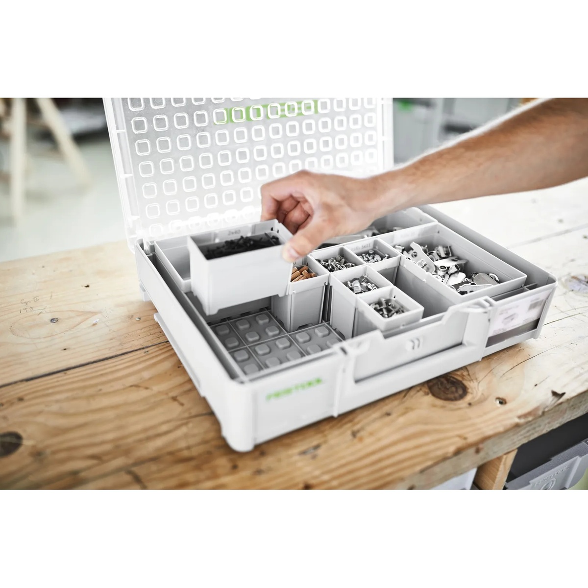 Festool 204856 Systainer3 Organizer L 89 with 20 Containers showing a removable plastic bin being lifted out during hardware organization on a woodworking bench