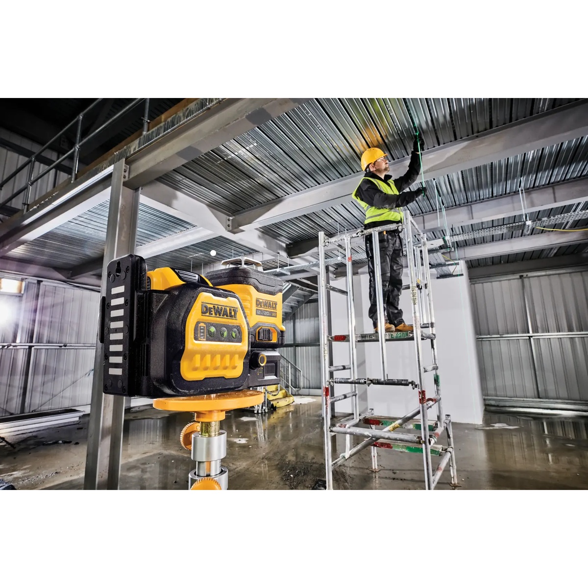 DEWALT DCLE34030GB 20V MAX XR 3 X 360 Green Line Laser mounted on a support for overhead ceiling layout in a steel-framed commercial interior