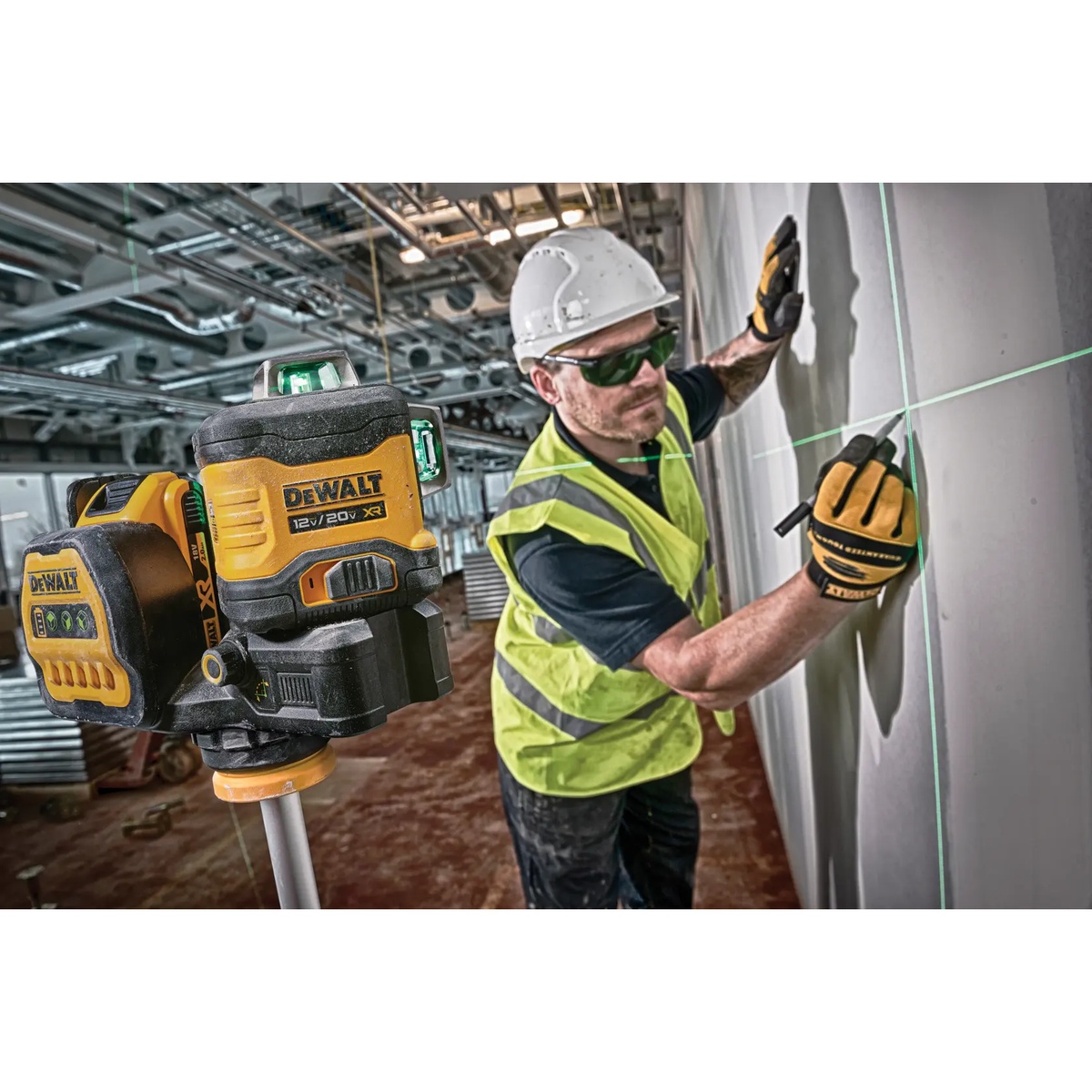 DEWALT DCLE34030GB 20V MAX XR 3 X 360 Green Line Laser projecting green reference lines on a wall during interior layout work on a commercial jobsite