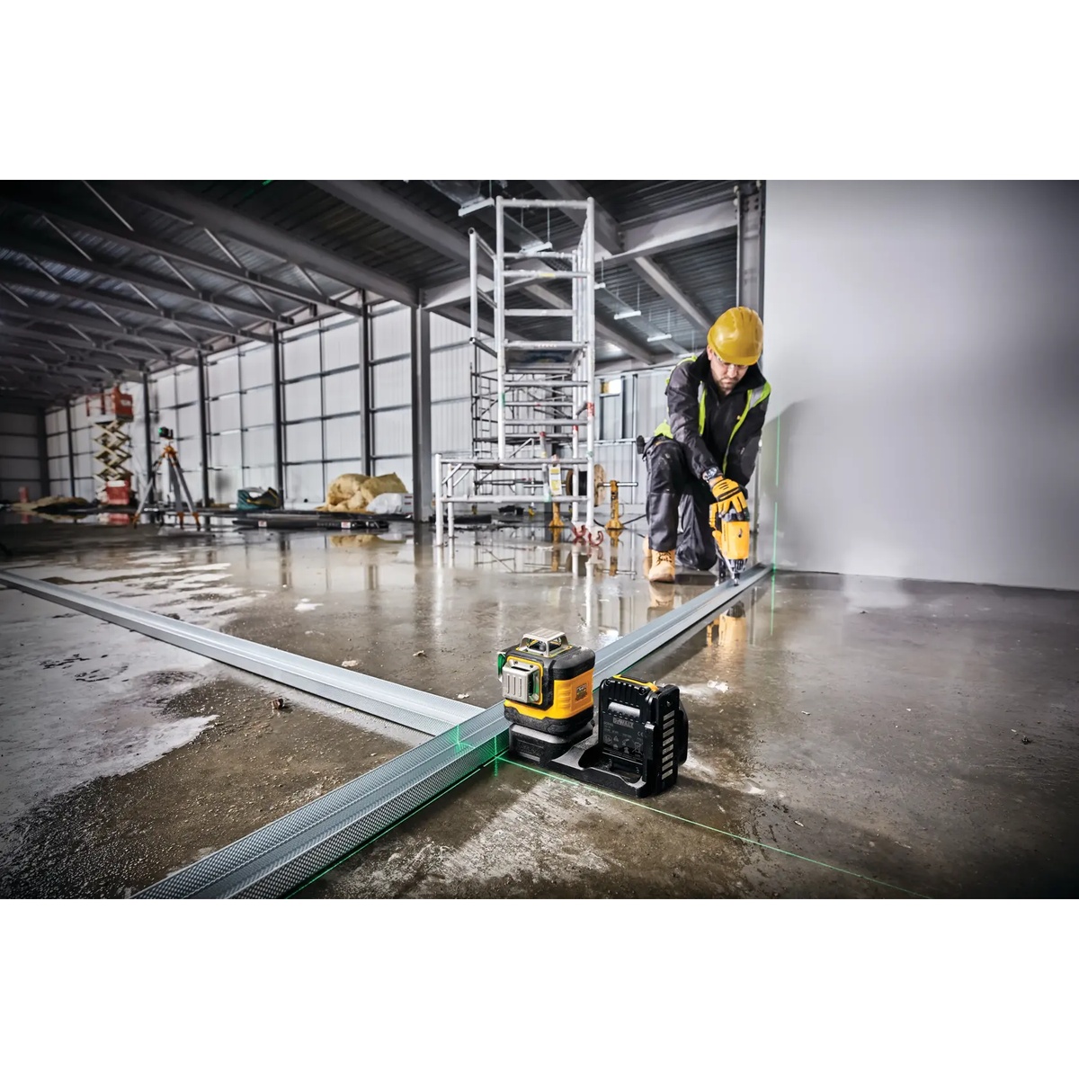 DEWALT DCLE34030GB 20V MAX XR 3 X 360 Green Line Laser set on the floor for metal track layout in a commercial construction space