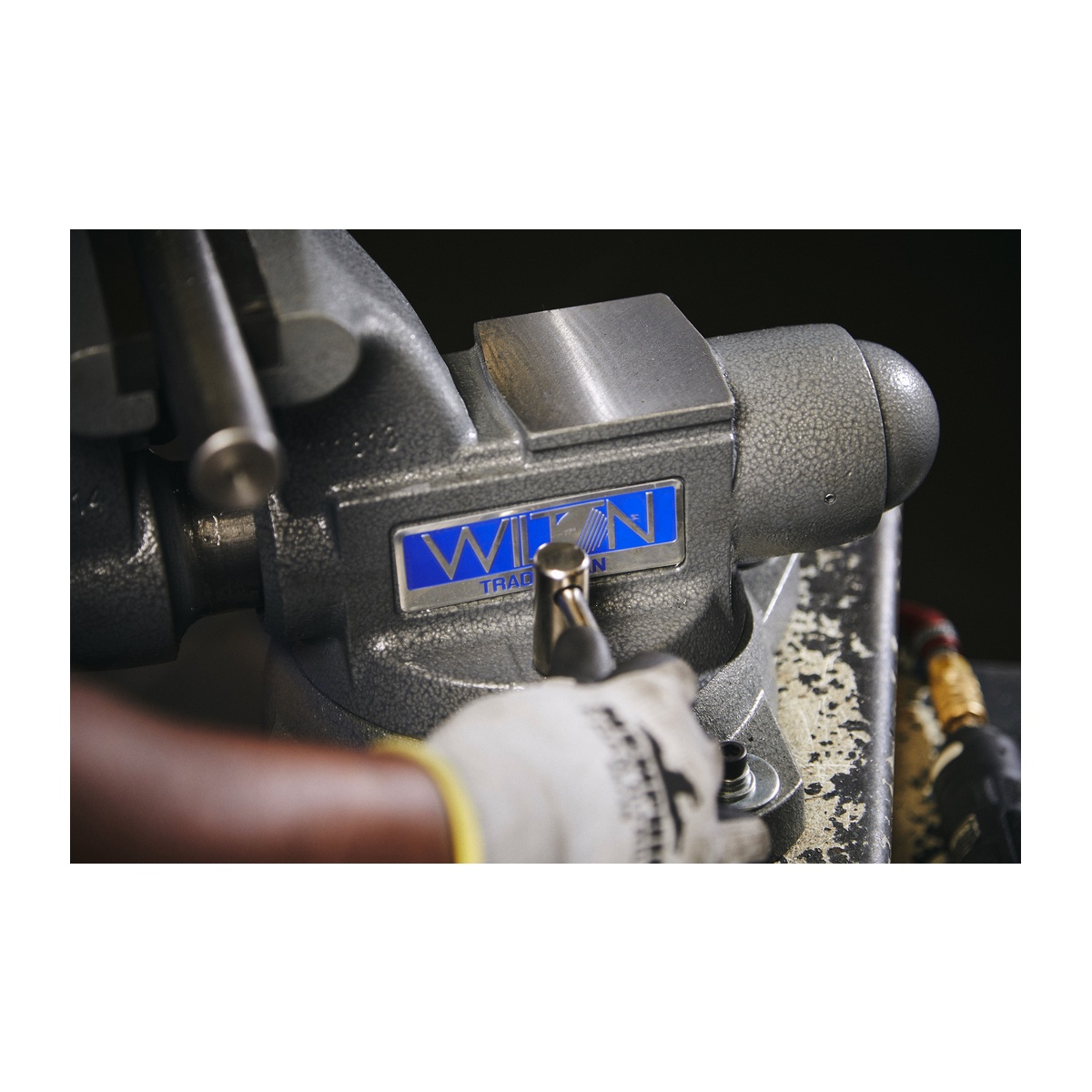 Close-up of the Wilton 28806 Tradesman 1755 Vise machined anvil and swivel base area on a workbench