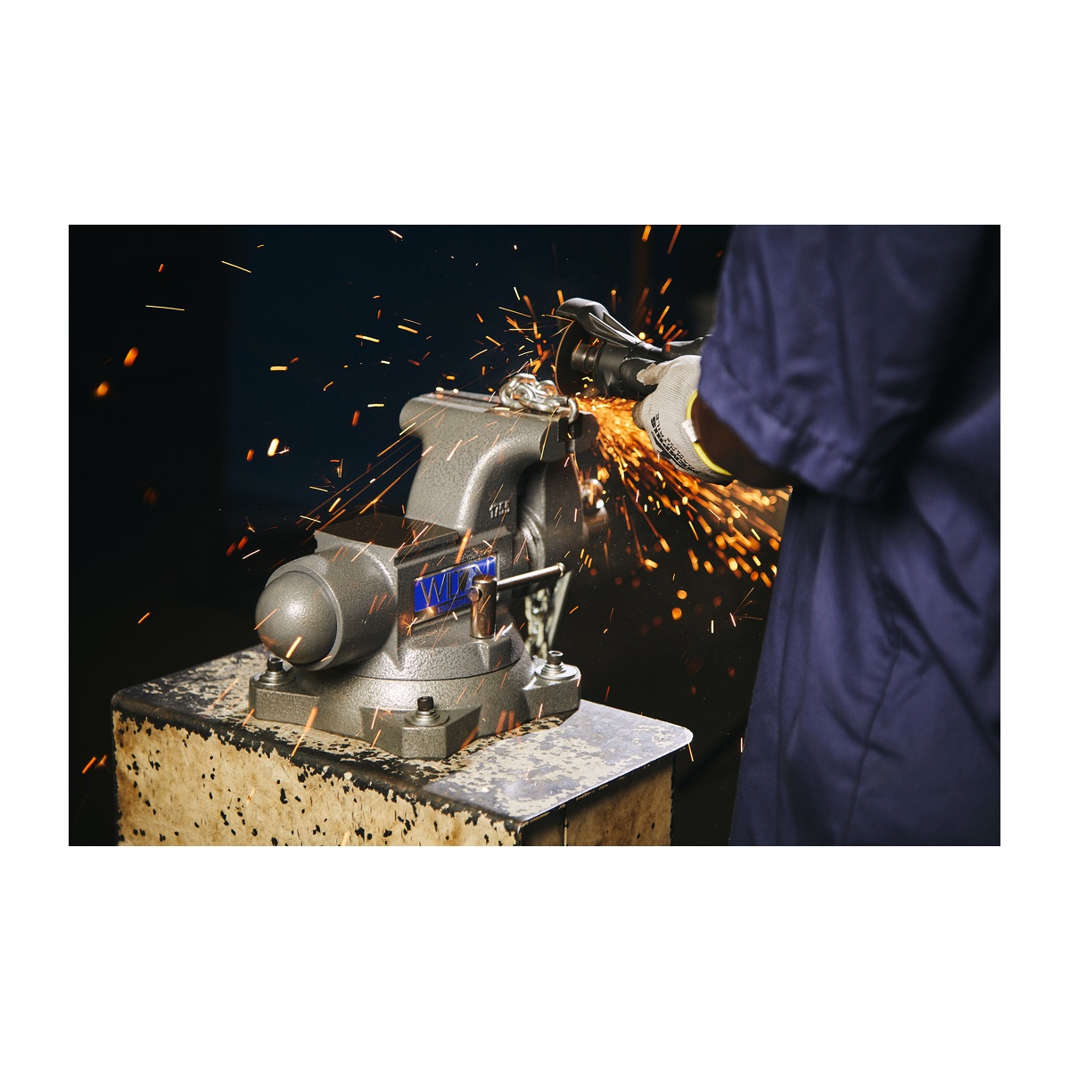 Wilton 28806 Tradesman 1755 Vise securing material while grinding with sparks in a fabrication shop