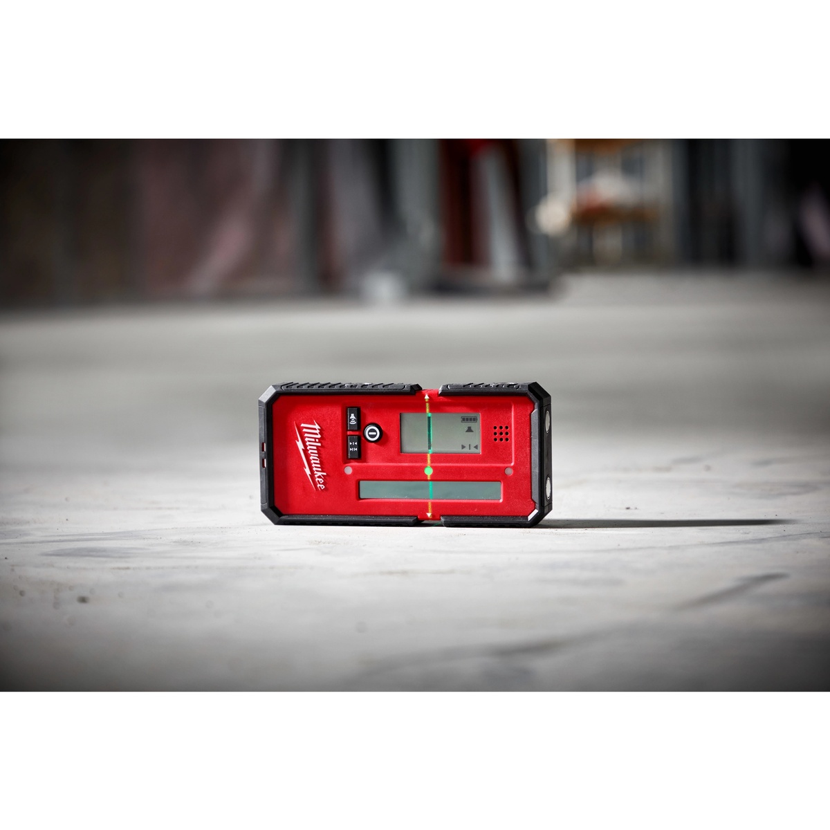 Milwaukee 48-35-1211 165' Laser Line Detector picking up a green laser line on a jobsite floor during interior layout work