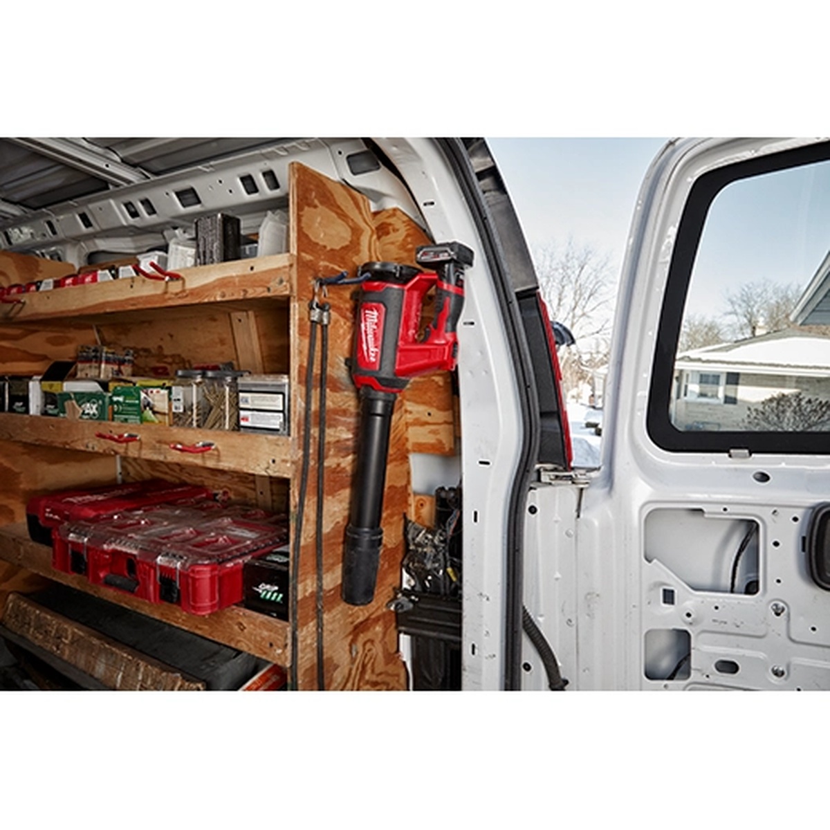 Milwaukee 0852-20 M12 Compact Spot Blower stored inside a work van for quick jobsite cleanup between service calls