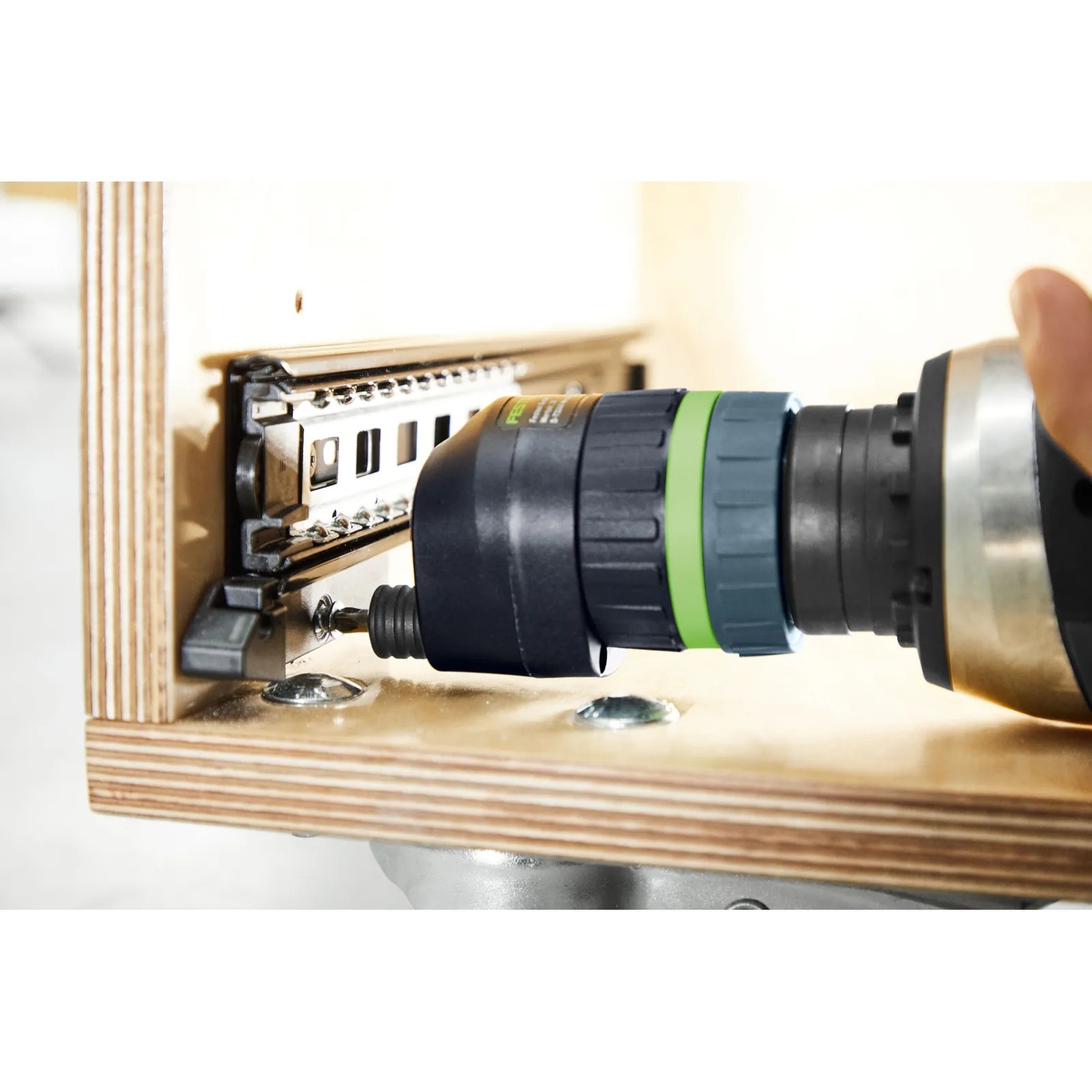 Festool 205223 Eccentric Attachment EX-UNI driving a screw inside a plywood cabinet near drawer slide hardware in a tight installation space
