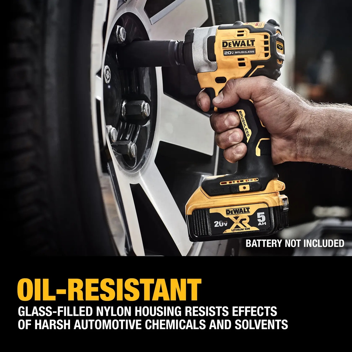 DeWALT DCF911B 20V MAX 1/2-in. impact wrench removing or tightening lug nuts on a vehicle wheel in an automotive workspace