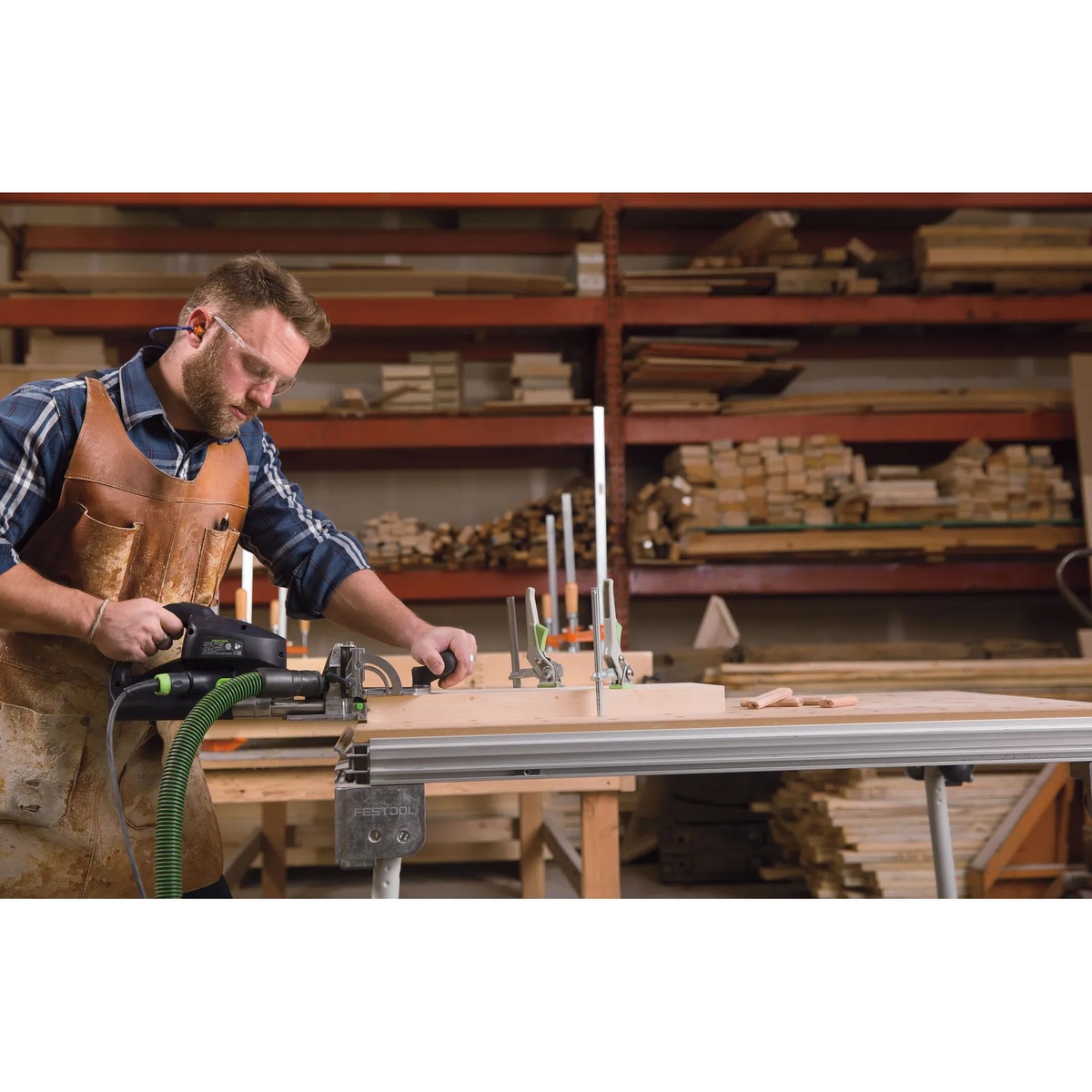 Festool DF 700 EQ-Set DOMINO Joiner XL cutting mortises in a large wood panel on a shop workbench for furniture joinery