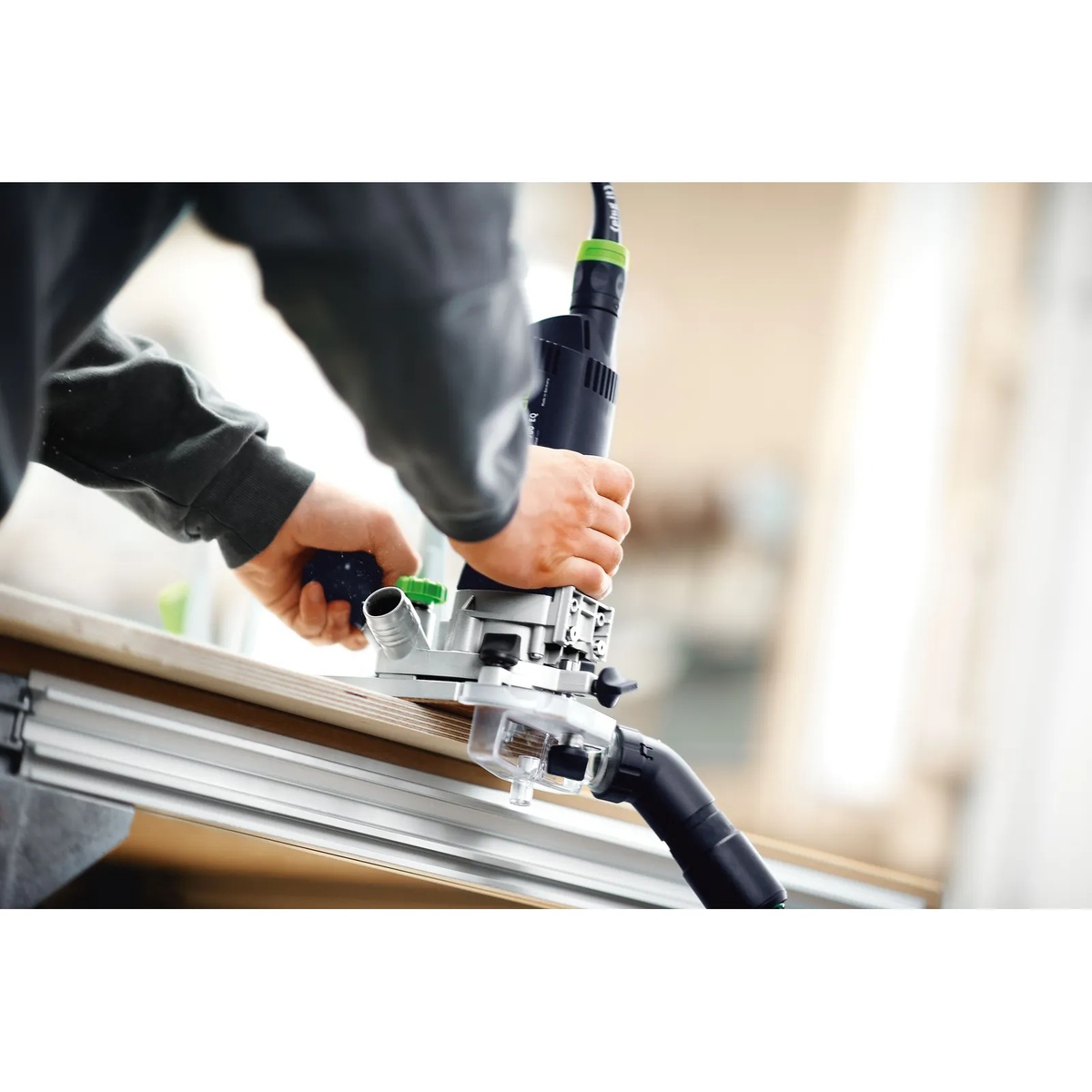Festool 576239 Module Edge Router MFK 700 Set trimming edge banding on a panel in a woodworking shop with dust extraction attached