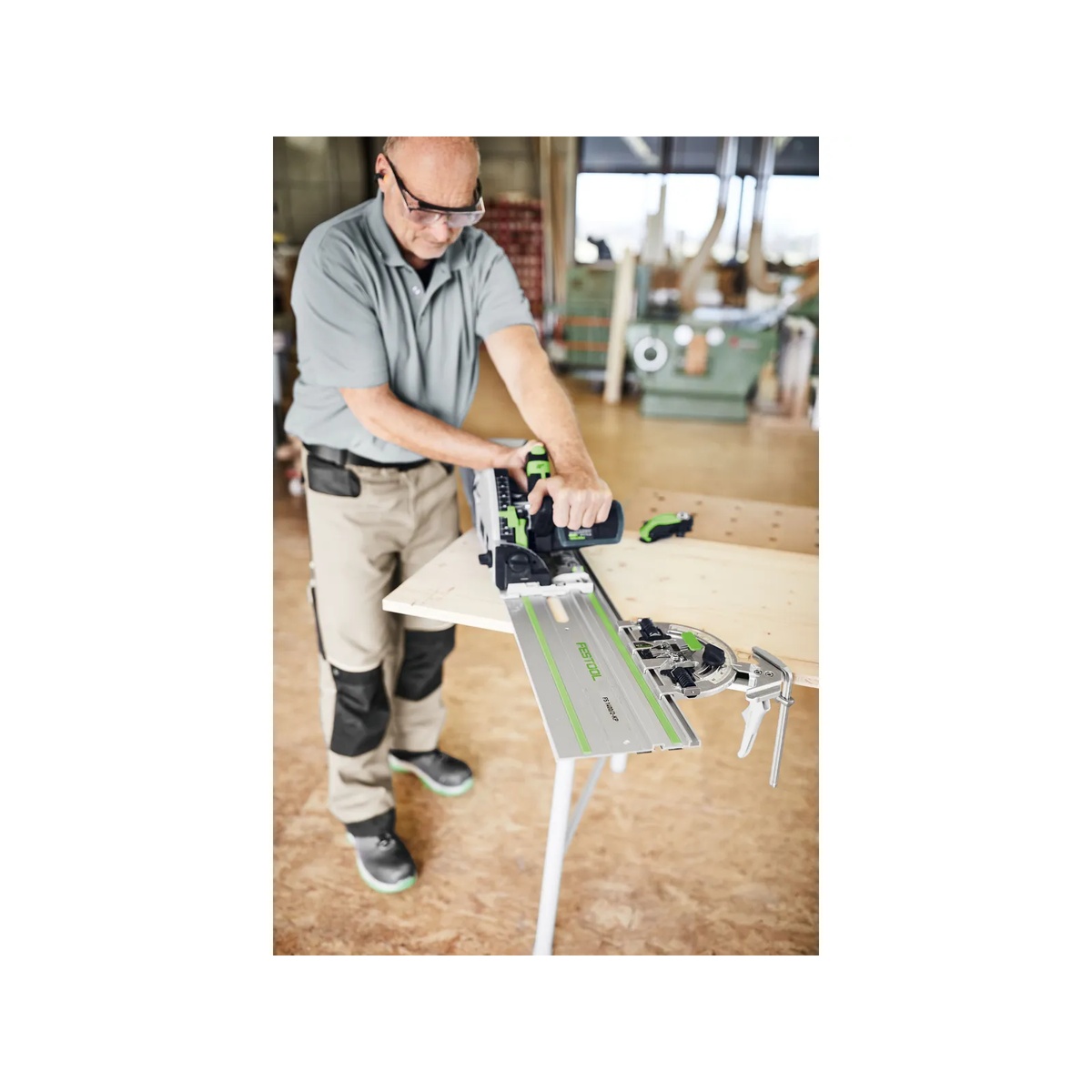 Festool 577040 Guide Rail Angle Stop FS-WA mounted on a Festool FS guide rail during track saw cutting on a wood panel in a workshop