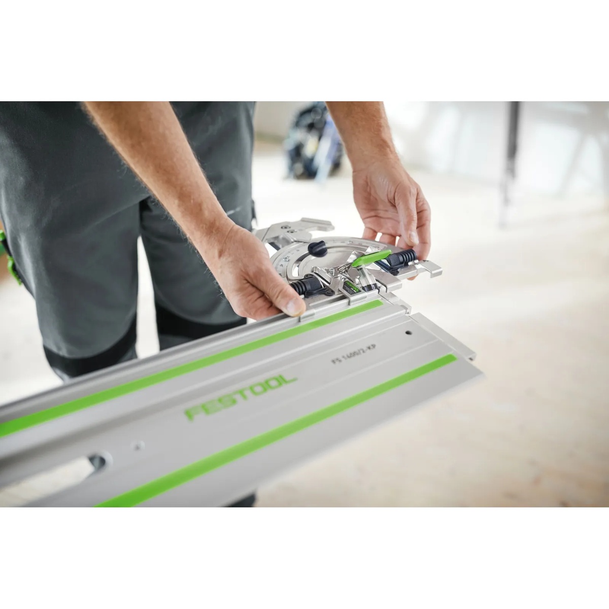 Festool 577040 Guide Rail Angle Stop FS-WA being attached by hand to a Festool guide rail on a work surface for angled cutting setup