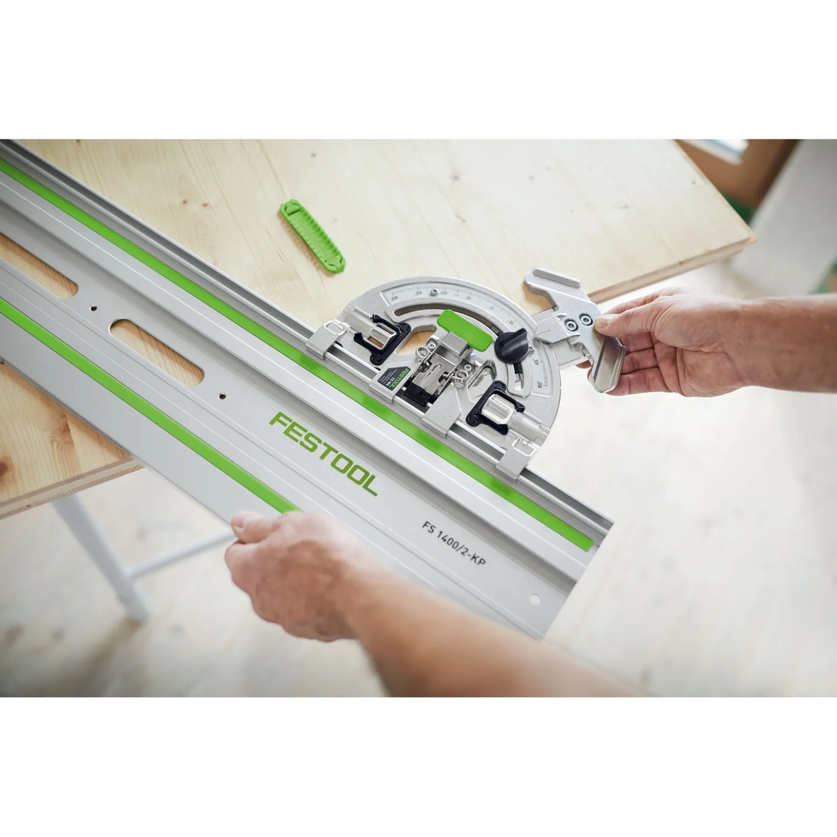 Festool 577040 Guide Rail Angle Stop FS-WA aligned on a Festool FS guide rail over a wood panel with the contact edge positioned at the workpiece