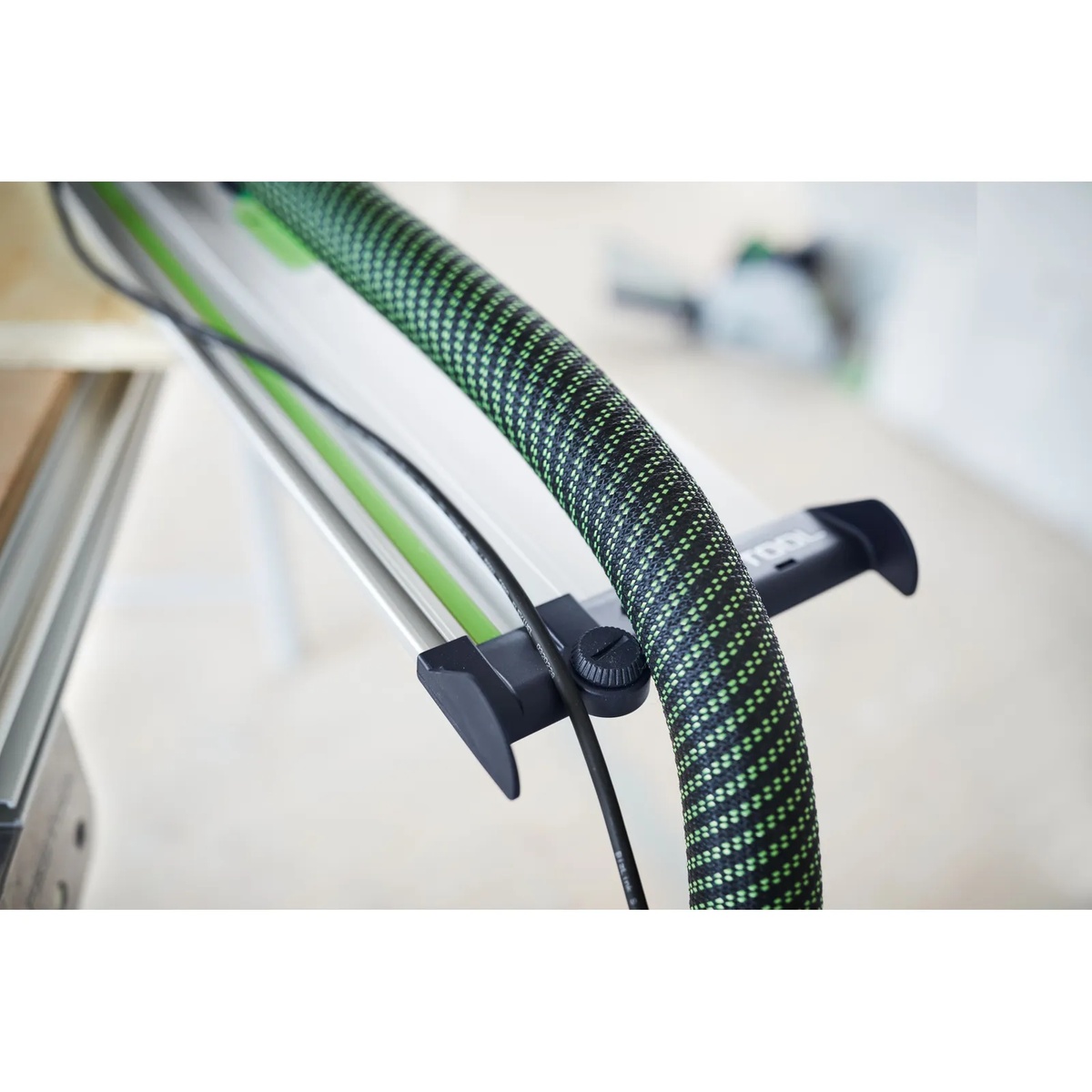 Festool 577157 Guide Rail Accessory Kit w/ Systainer3 deflector mounted on an FS/2 guide rail to manage a dust hose and cord during cutting