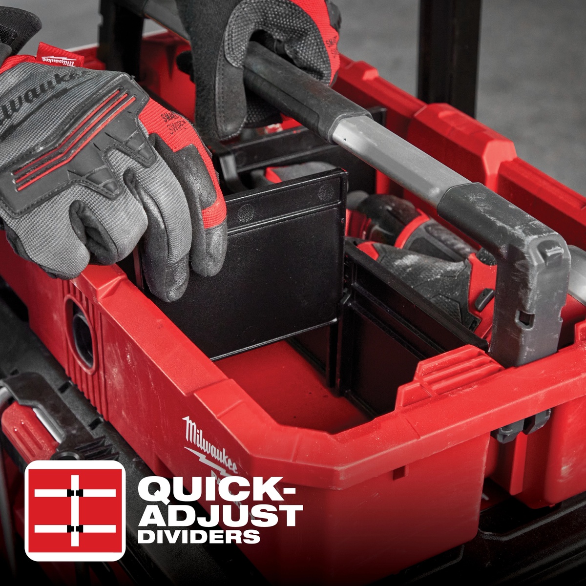 Milwaukee 48-22-8045 PACKOUT Tool Tray with quick-adjust dividers being repositioned by a gloved user on a jobsite to organize tools and accessories