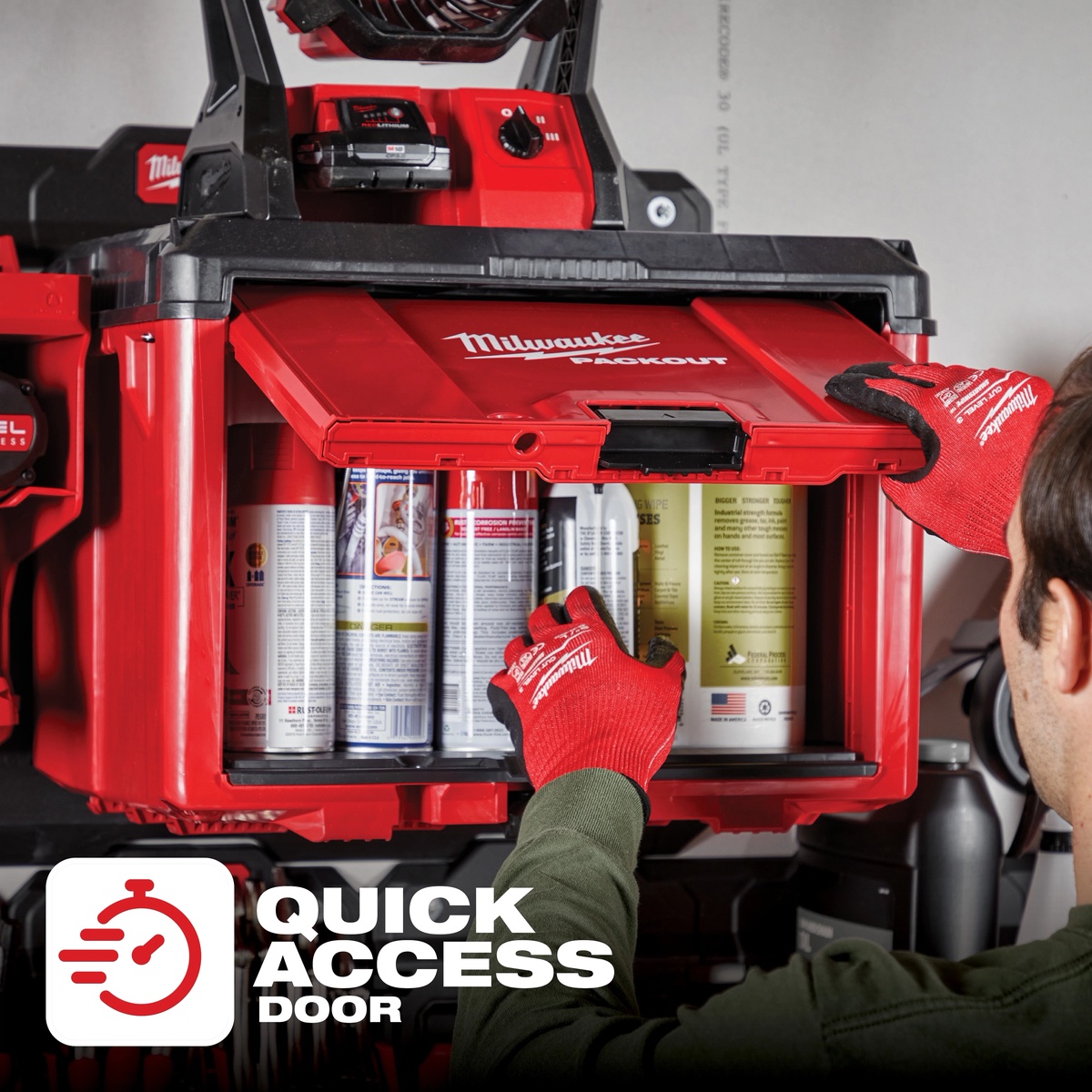 Milwaukee 48-22-8445 PACKOUT Cabinet mounted in a shop setup with the quick-access door open for grabbing cans and supplies from organized storage