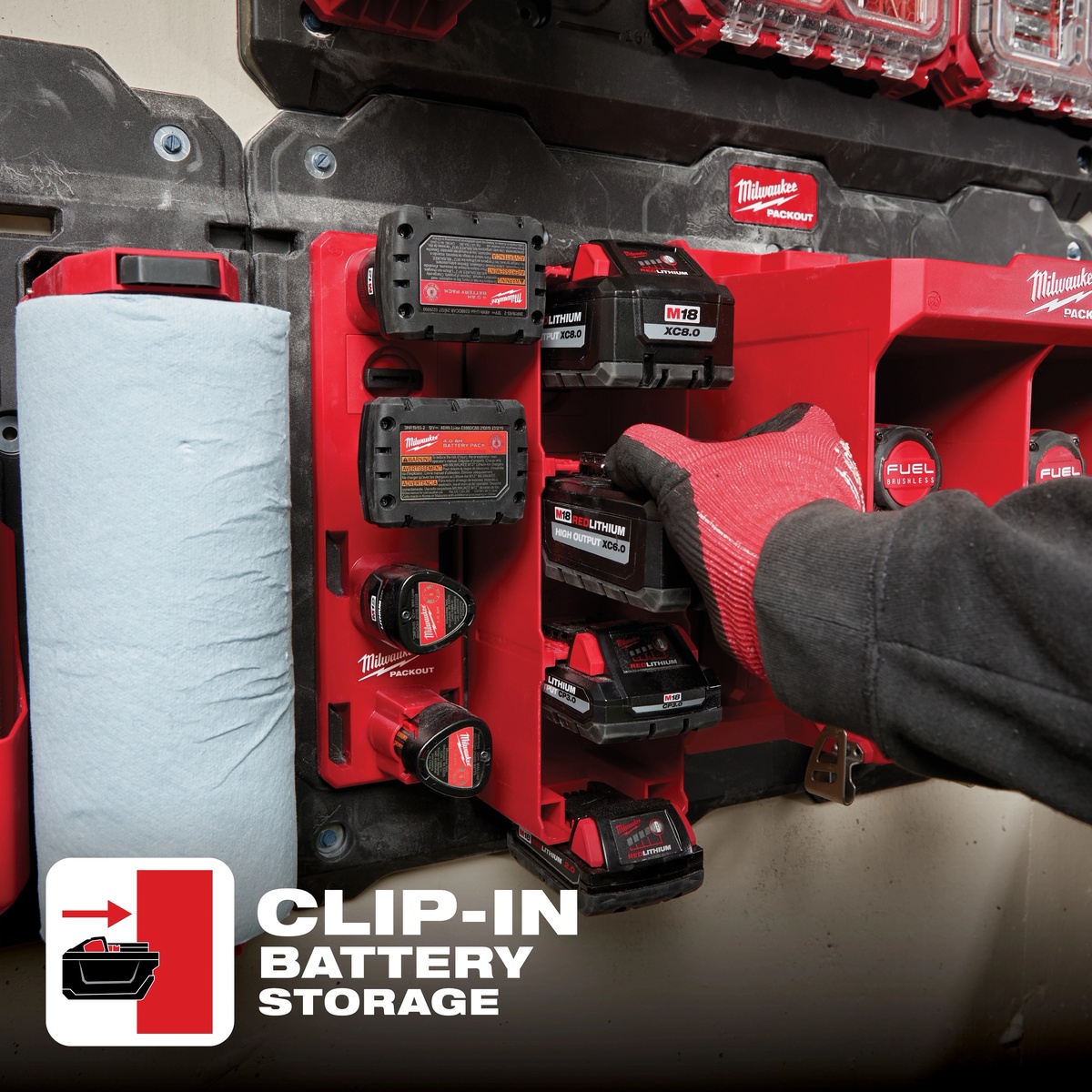 Milwaukee 48-22-8339 PACKOUT M18 Battery Rack mounted on a PACKOUT wall plate holding multiple M18 batteries in a workshop storage setup