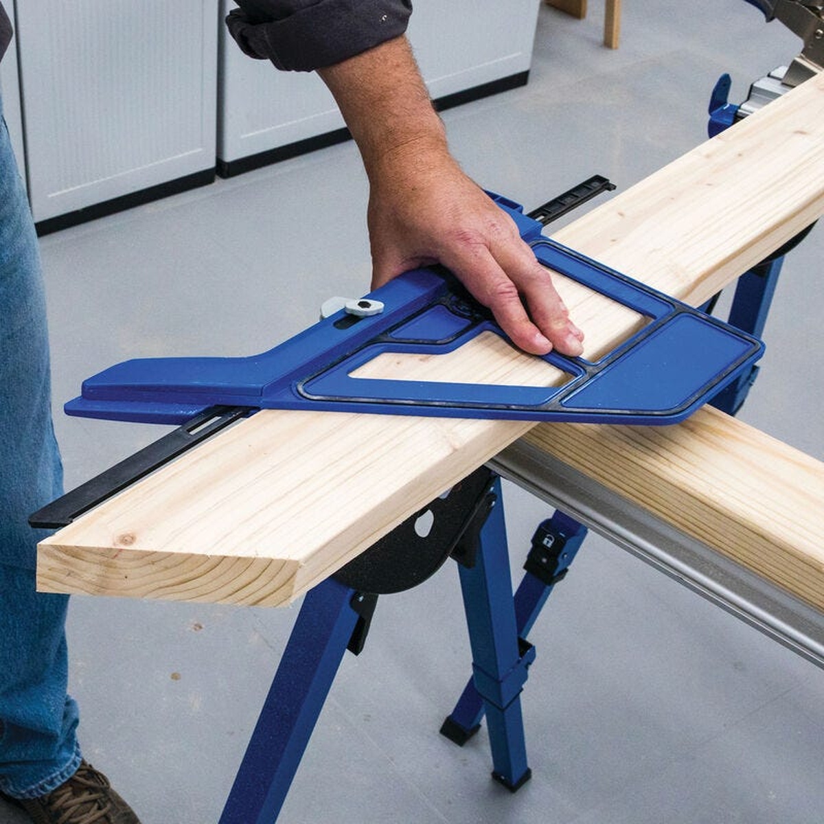 Kreg KMA4000-E Kreg Portable Circular Saw Crosscut Jig positioned on a board to guide an accurate angled cut on a work stand