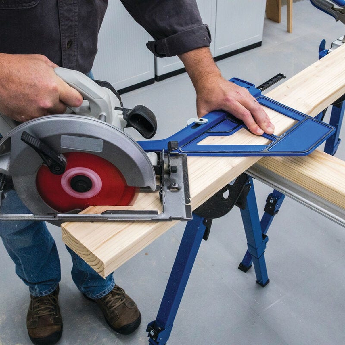Kreg KMA4000-E Kreg Portable Circular Saw Crosscut Jig guiding a circular saw for a straight crosscut on a board on sawhorses