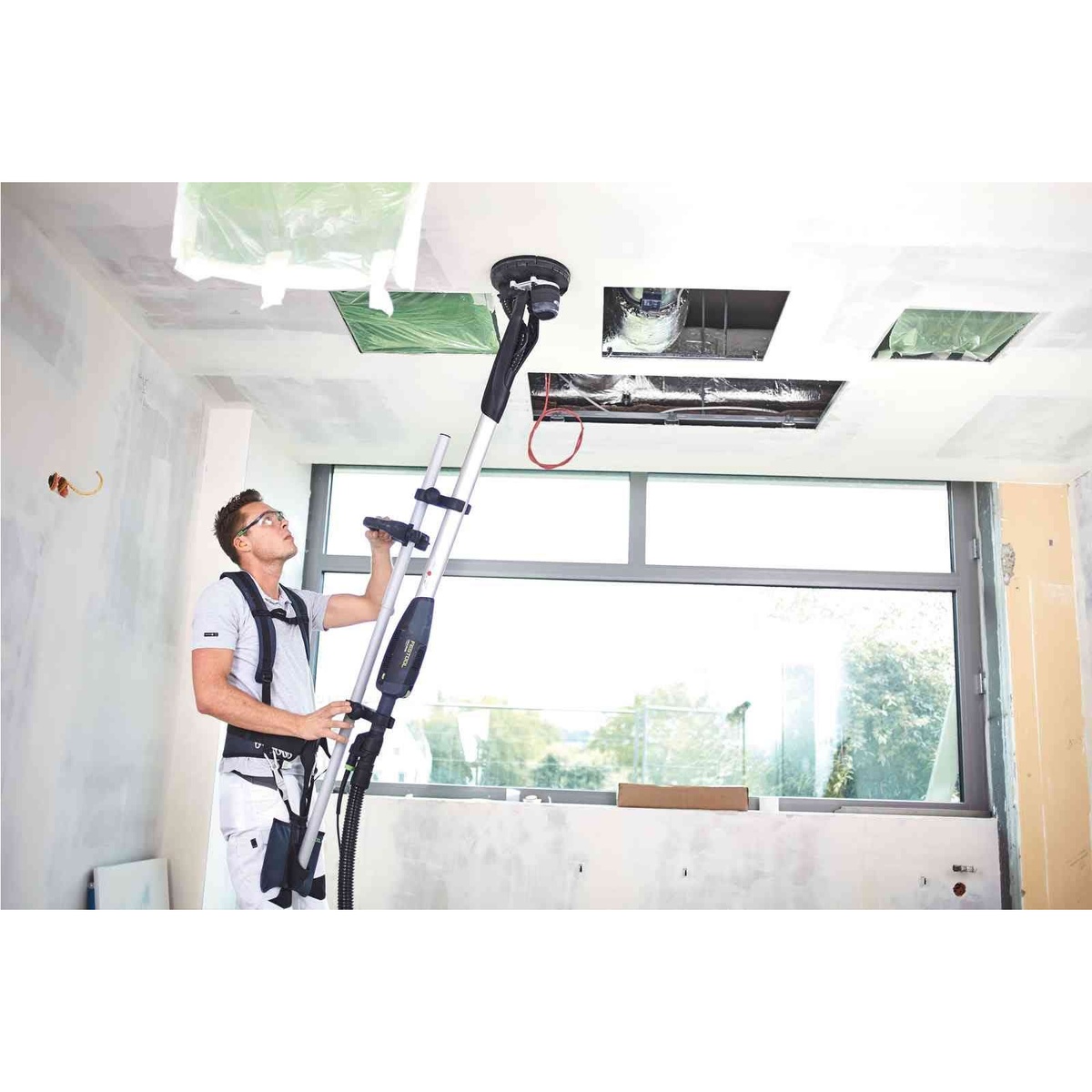 Festool 576802 PLANEX Drywall Sander Harness TG-LHS 225 w/ Systainer3 supporting a PLANEX drywall sander during ceiling sanding in a residential remodel room