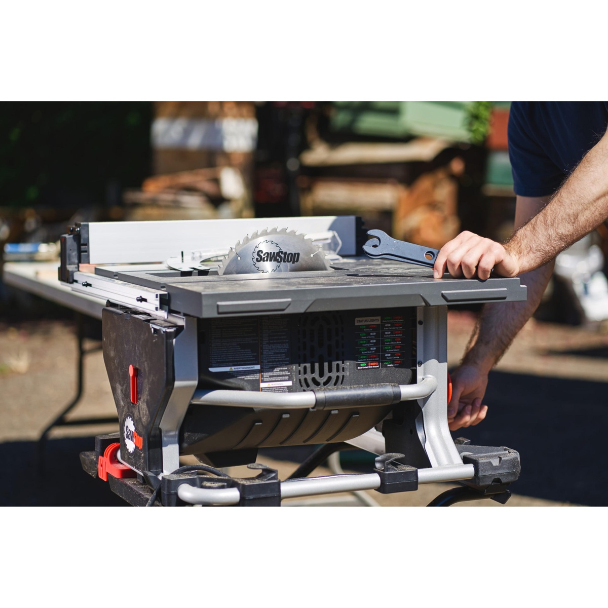 SawStop CTS-120A60 10 inch Compact Table Saw with blade raised during setup on an outdoor worksite showing full size cutting capacity in a portable saw