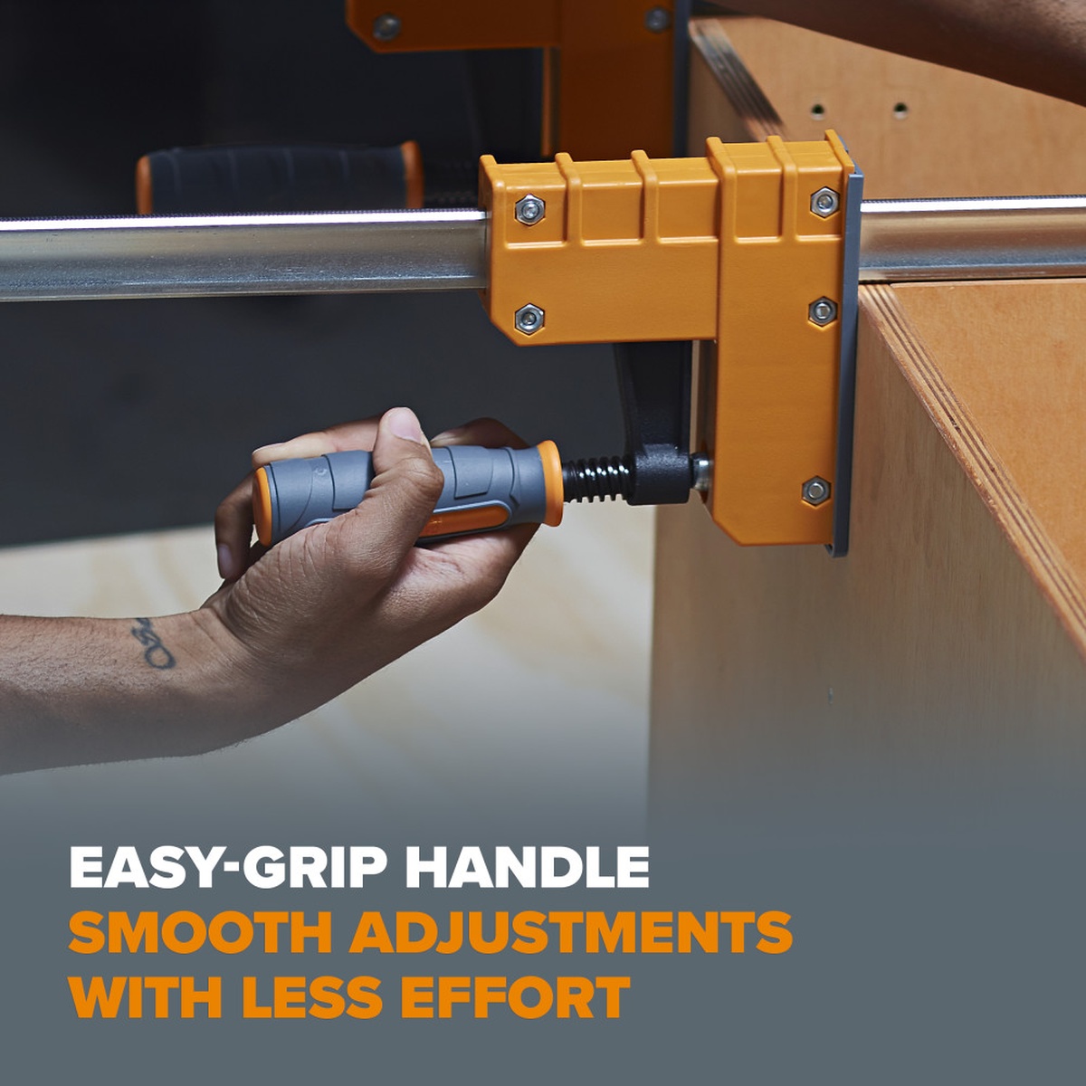 Close-up of the Bora 571550I 4-Piece Parallel Clamp Set handle being tightened on a plywood cabinet assembly in a woodworking shop