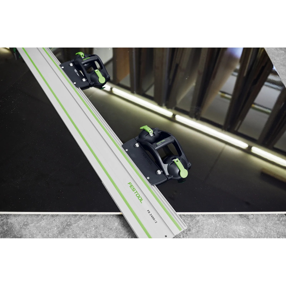 Festool 577294 Gecko Suction Handle with AD-DOSH-FS Guide Rail Adapter securing a Festool guide rail on a smooth non-porous panel for precise cutting setup