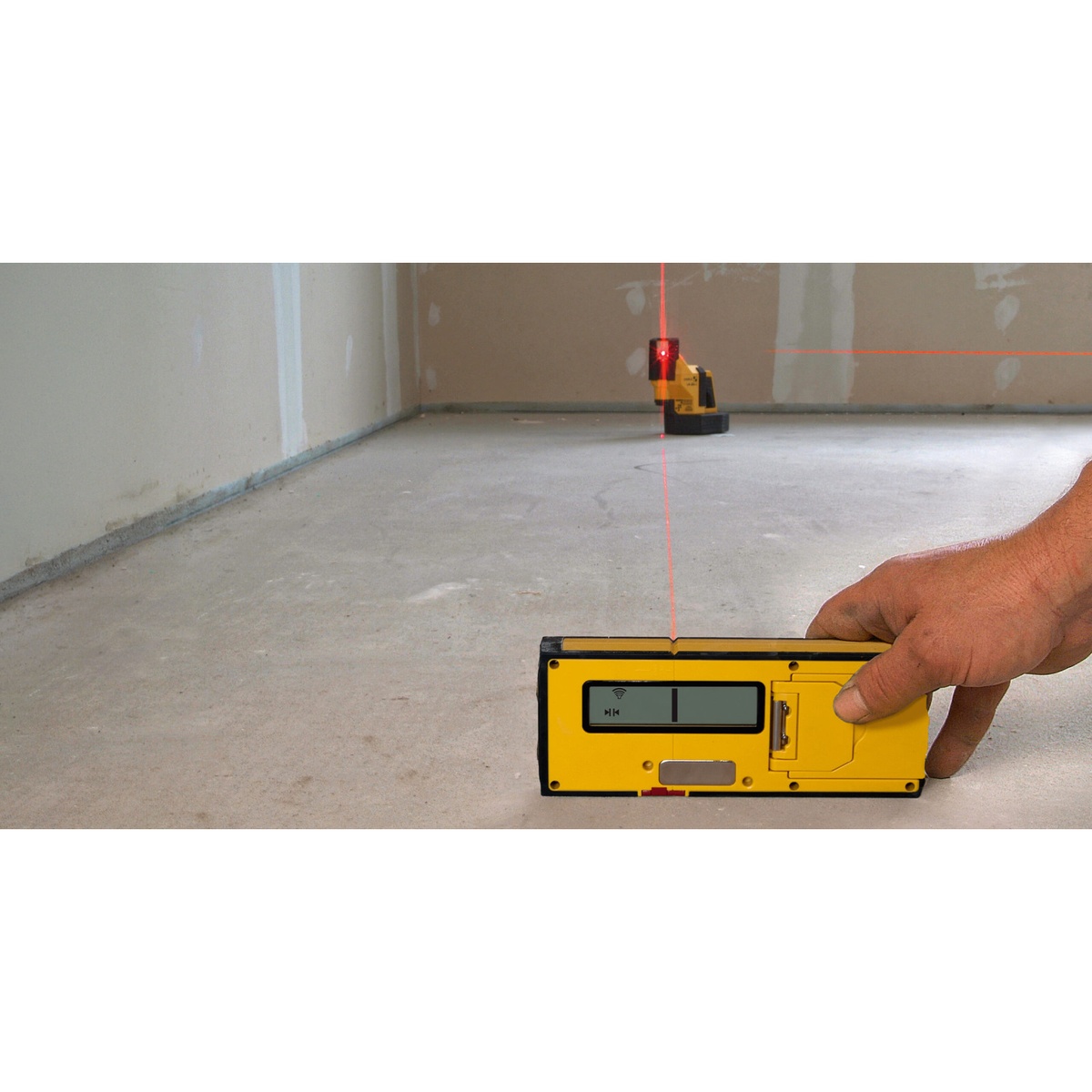 Stabila REC 410 Line RF Receiver for LA180L detecting a red laser line on an indoor concrete floor during layout work