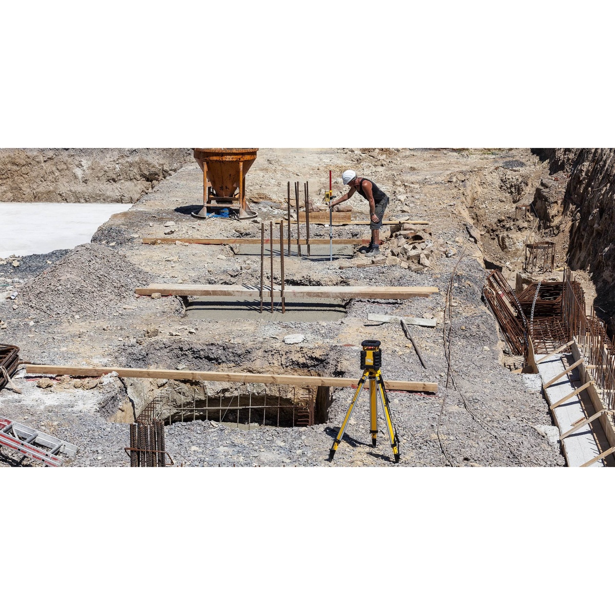 Stabila 07469 Hi-Lo Elevation Rod being used with a laser receiver to check grade at an excavation and footing layout area