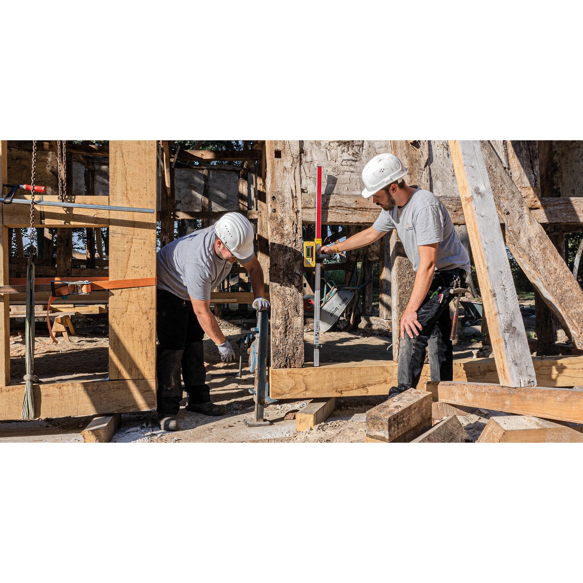 Stabila 07530 Receiver Bracket mounted to a grade rod on a construction site for rotating laser receiver elevation checks