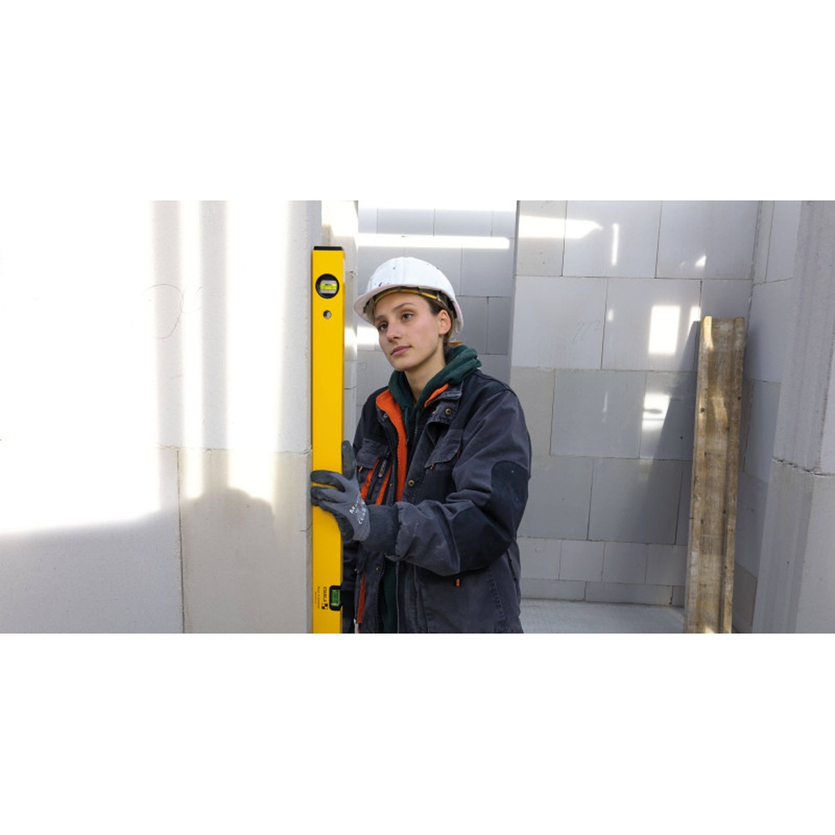 Stabila 22924 24 in Type 70A-2 Level being used to check plumb on a masonry wall opening on a jobsite
