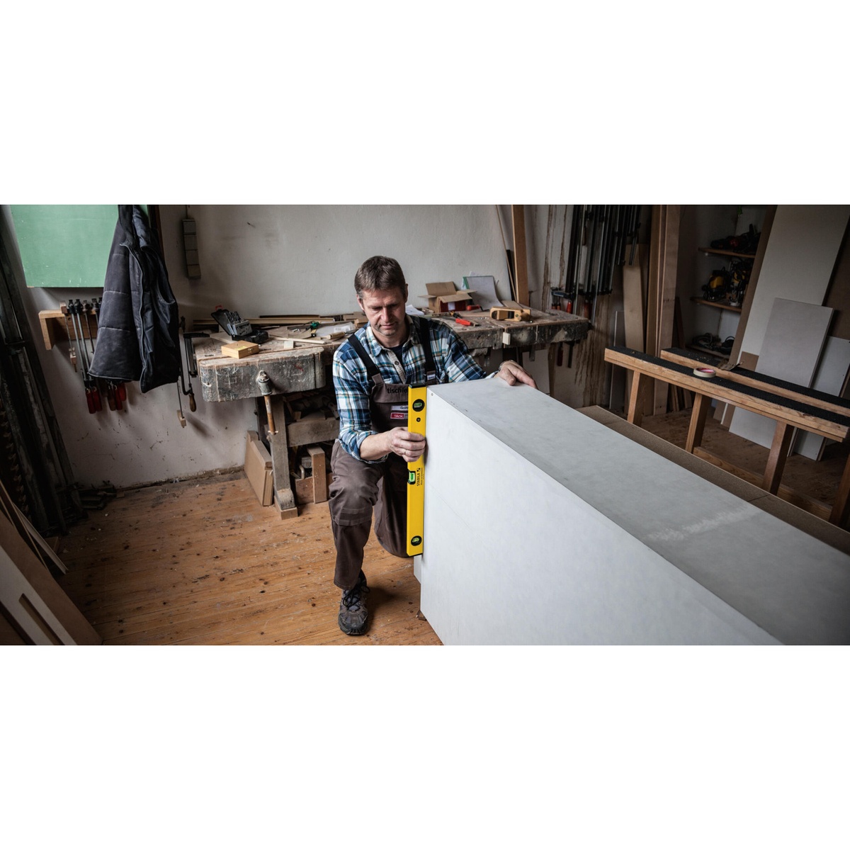 Stabila 22924 24 in Type 70A-2 Level checking plumb on a large panel in a workshop setting