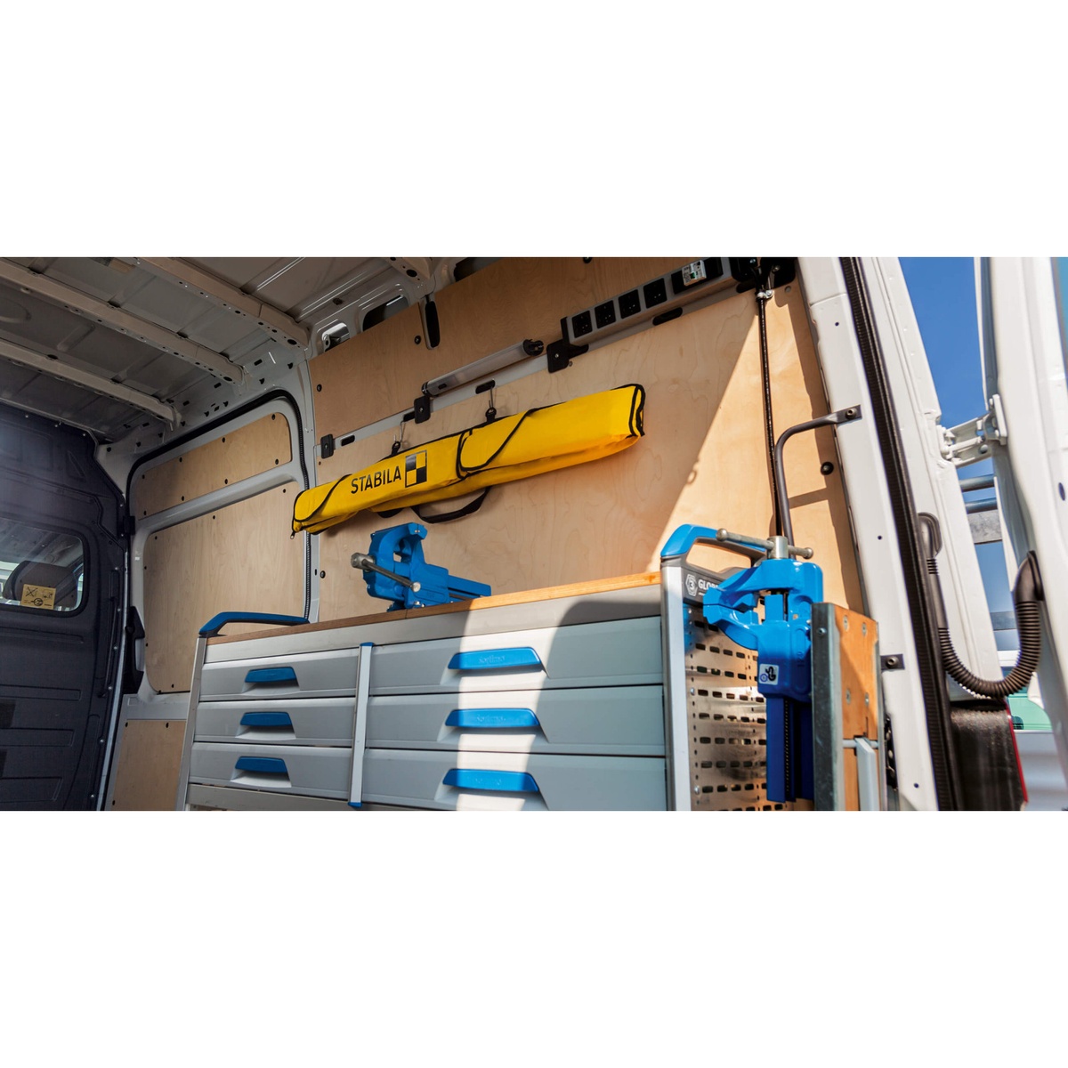 Stabila 30030 96 in. Level Case hanging inside a work van to keep a long level protected and off the floor during transport