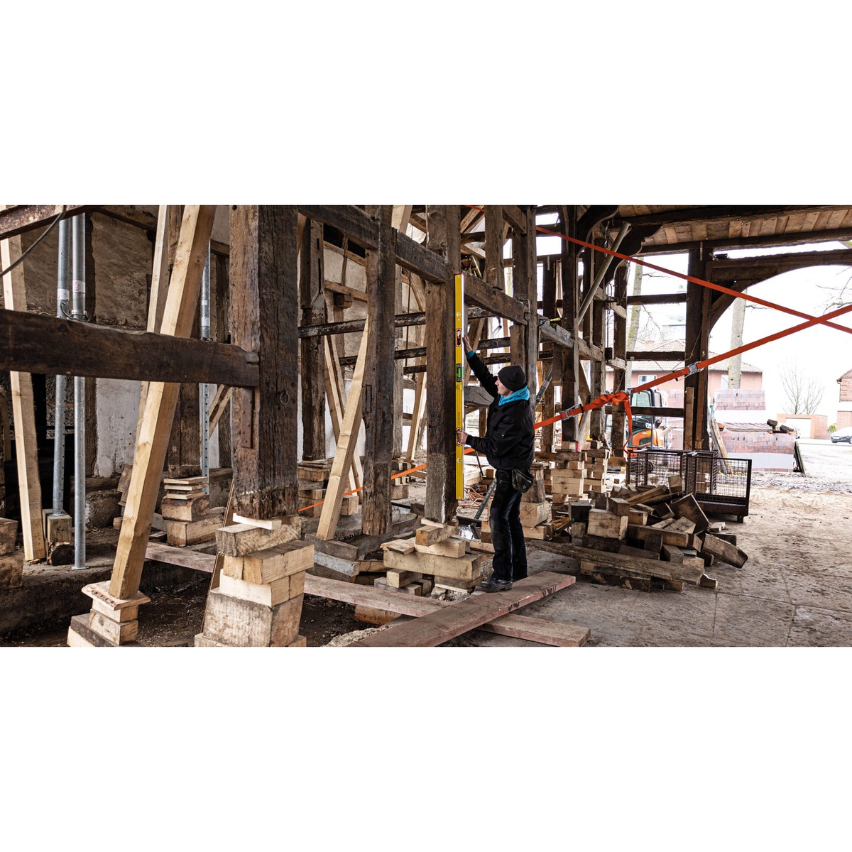 Stabila 36100 Electronic Level being used to check vertical alignment on heavy timber framing during structural restoration work