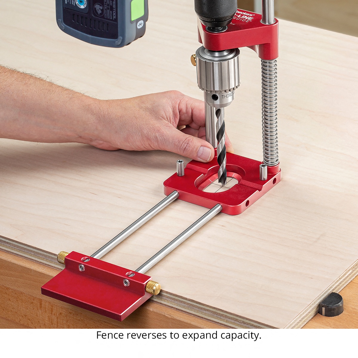 Woodpeckers ALDG-21 Auto-Line Drill Guide aligned on a plywood panel for accurate hole drilling at a workbench