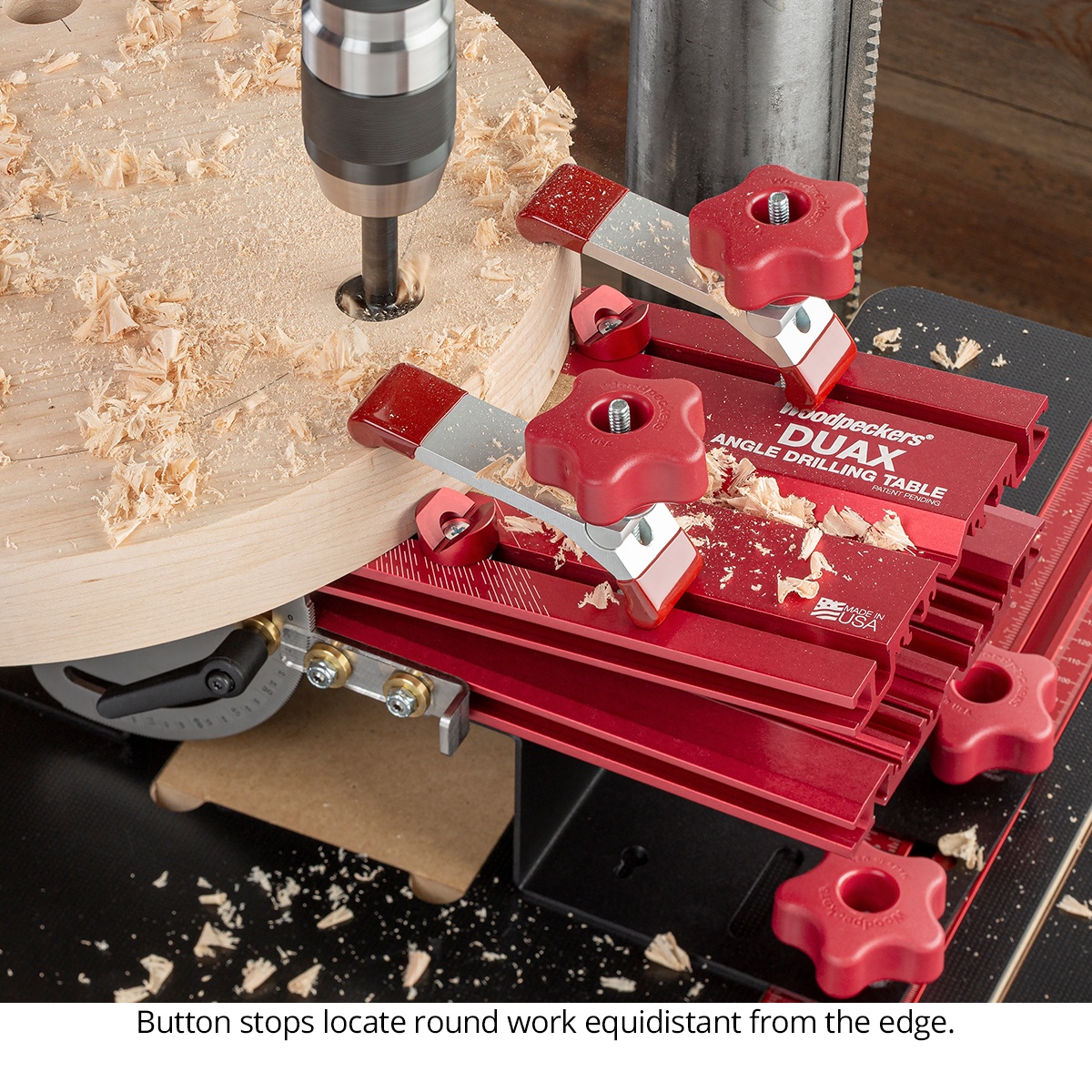 Woodpeckers DUAX-DEL Duax Angle Drilling Table - Deluxe Kit using button stops to locate a round workpiece on the drill press table for consistent hole placement