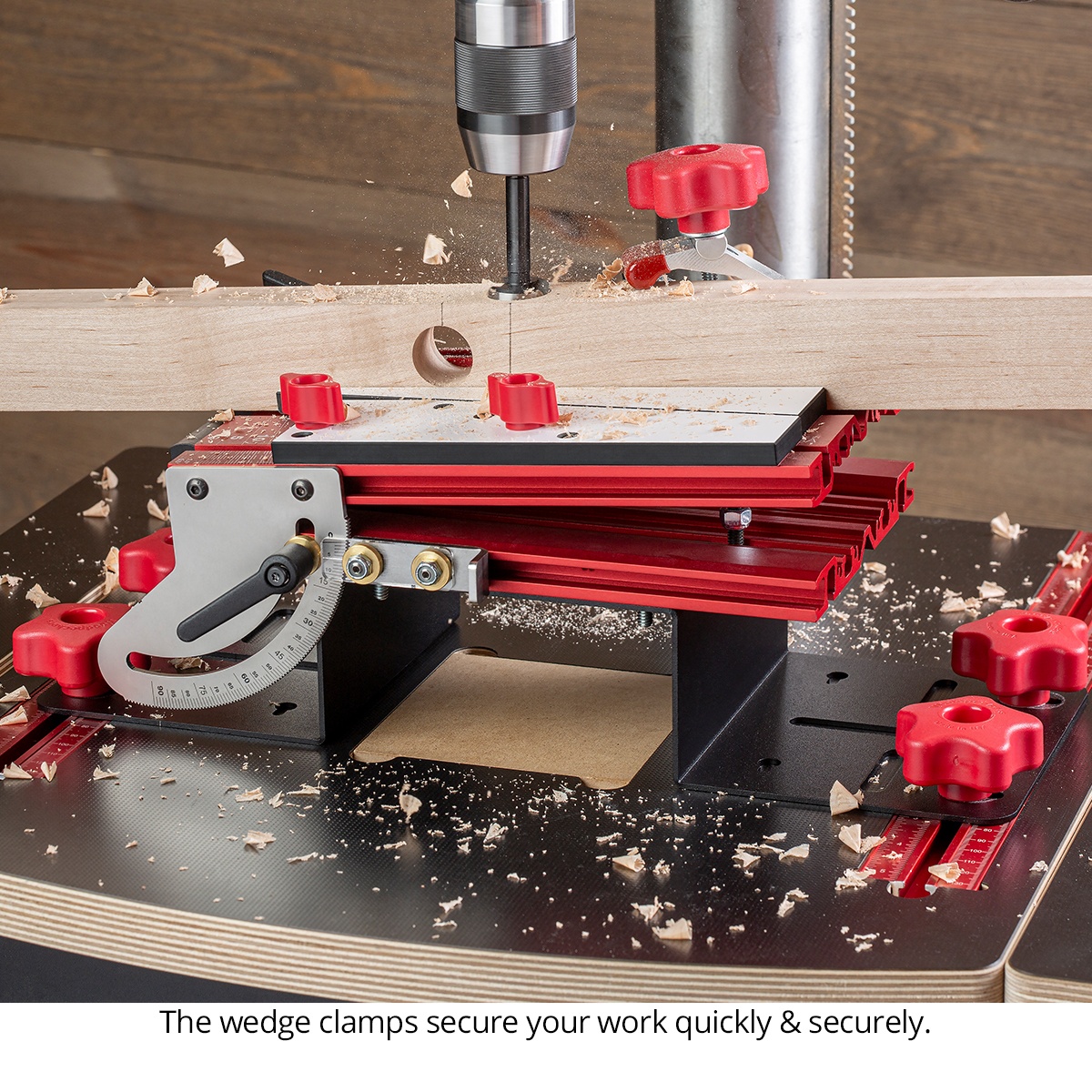 Woodpeckers DUAX-DEL Duax Angle Drilling Table - Deluxe Kit using the wedge clamping system to secure a long board for angled drilling on a drill press