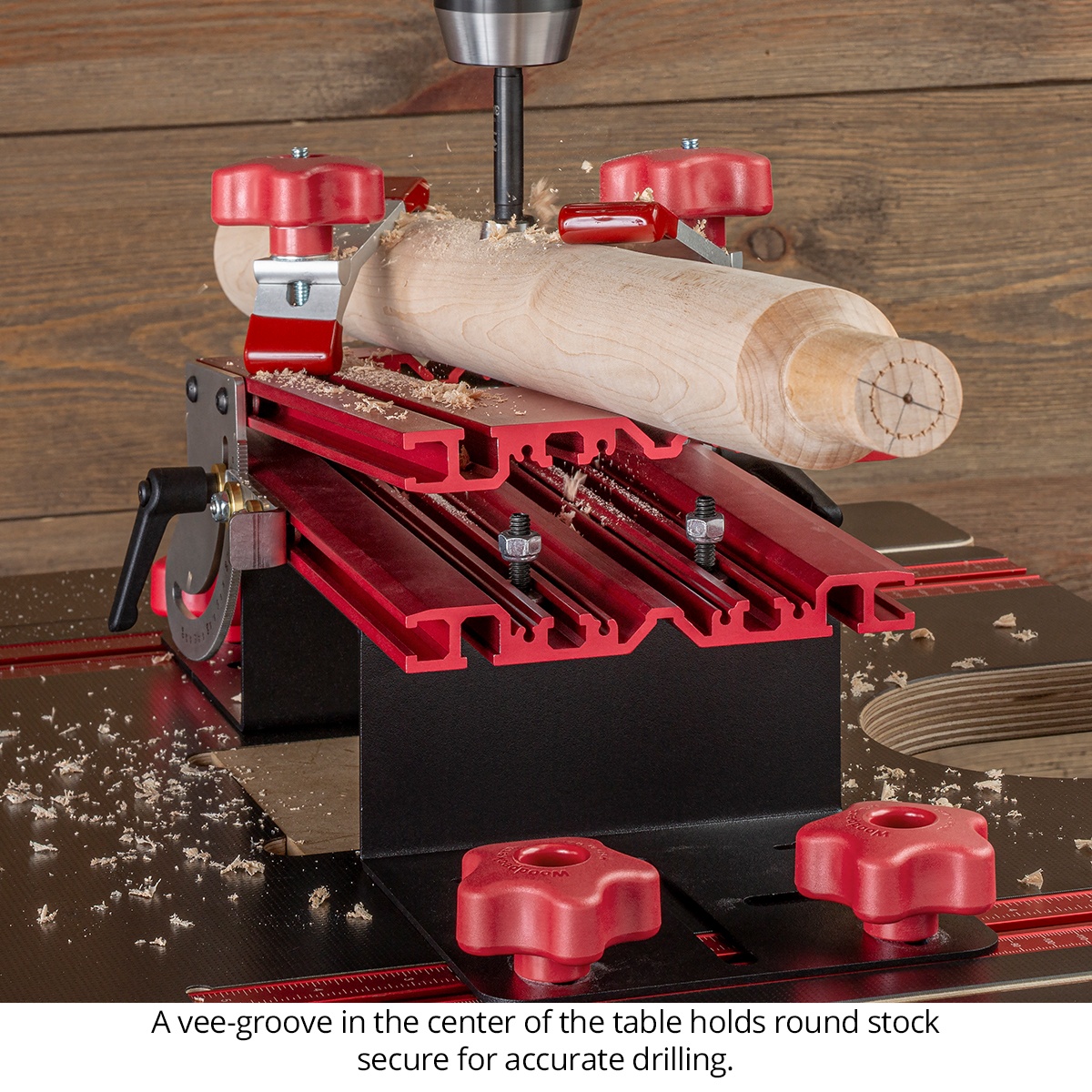Woodpeckers DUAX-DEL Duax Angle Drilling Table - Deluxe Kit holding a round spindle in the center vee-groove while drilling on a drill press
