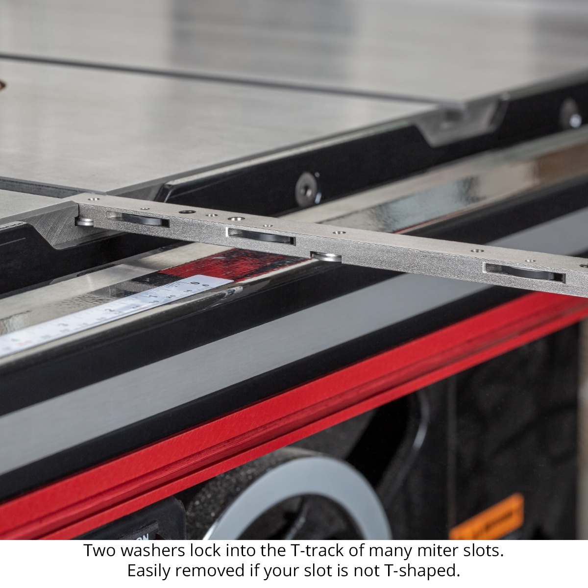 Underside of the Woodpeckers EXACT-90 Miter Gauge bar showing T-track washers engaged in a table saw miter slot for stable woodworking cuts