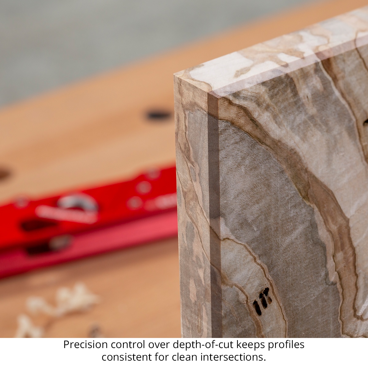 Woodpeckers EZ Edge Corner Plane profile shown on a hardwood board edge in a woodworking shop, highlighting consistent edge shaping at the corner intersection
