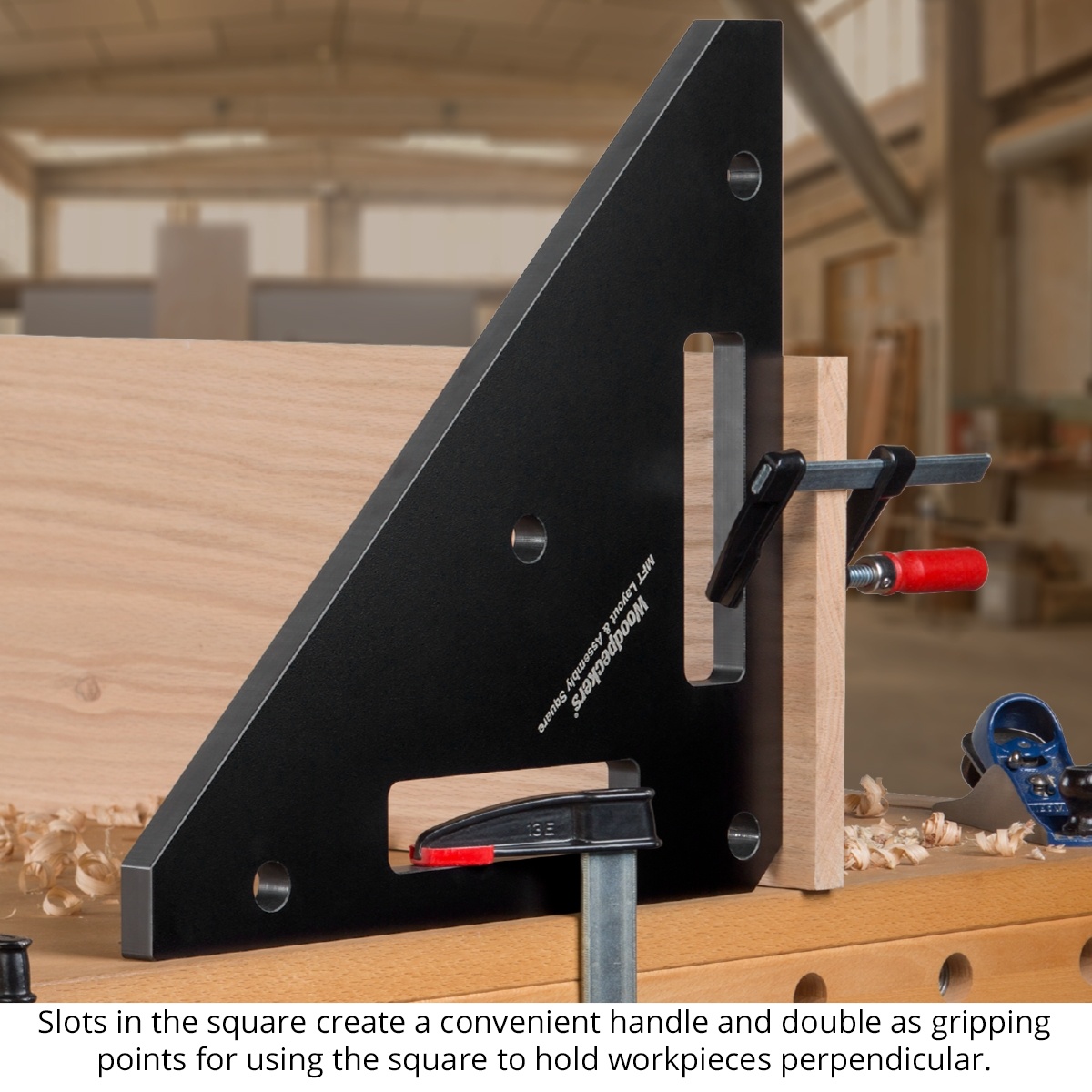 Woodpeckers MFT Layout & Assembly Square clamped against wood panels to hold workpieces perpendicular during cabinet assembly on a woodworking bench