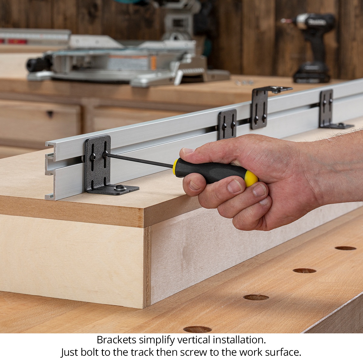 Woodpeckers StealthStop mounting bracket being installed on a woodworking station with a hex key for vertical track setup