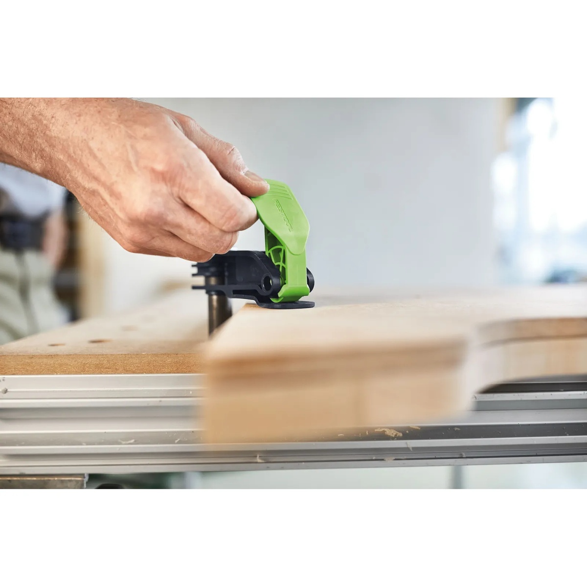 Festool Quick Clamp MFT-HZ 80 being engaged by hand on a workbench to secure a wood board for machining