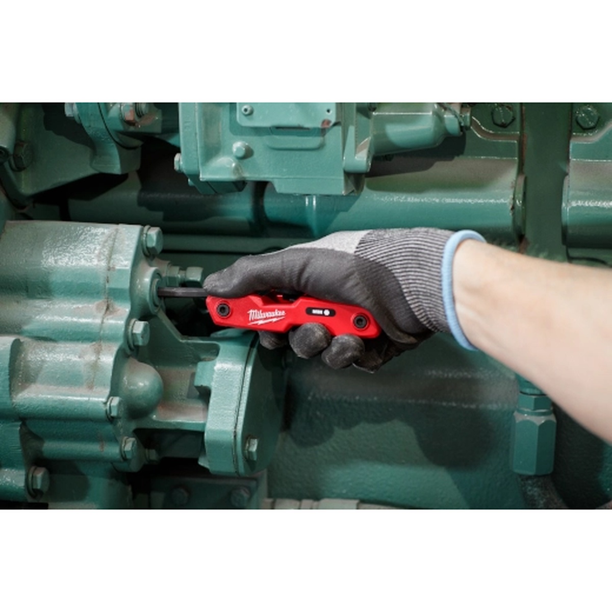 Milwaukee 48-22-2183 17-Piece Folding Hex Key Set - SAE & Metric loosening a machine fastener during maintenance work in tight equipment access