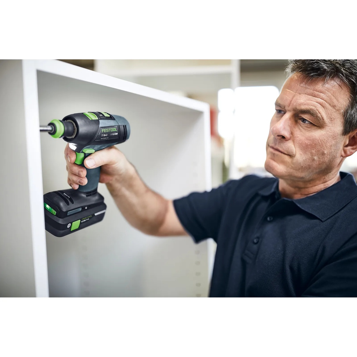 Festool 577608 T 18 Cordless Drill HighPower 4.0Ah SET Kit w/ Systainer3 driving a fastener inside a white cabinet during installation work