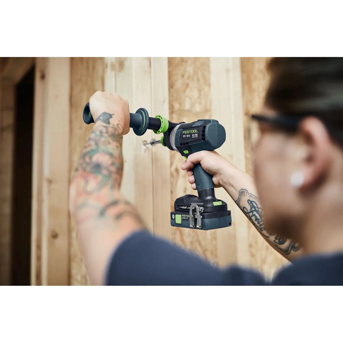 Festool 577627 QUADRIVE TPC 18/4 Cordless Hammer Drill boring into wall framing lumber during construction work