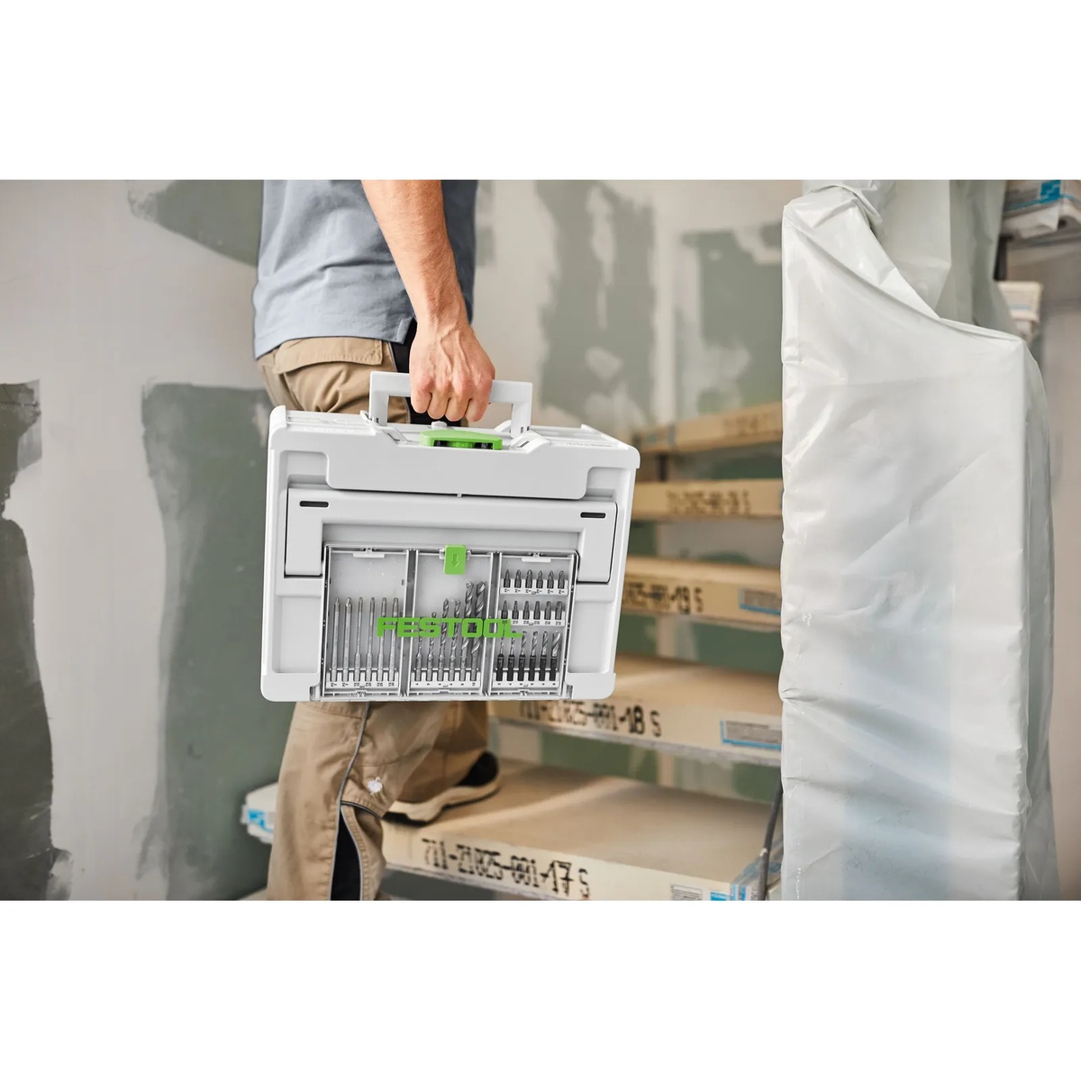 Festool 577780 12-Piece Driver Bit Cassette BKS SYS3 50mm CE F stored in a Festool Systainer being carried on a jobsite stairway during installation work